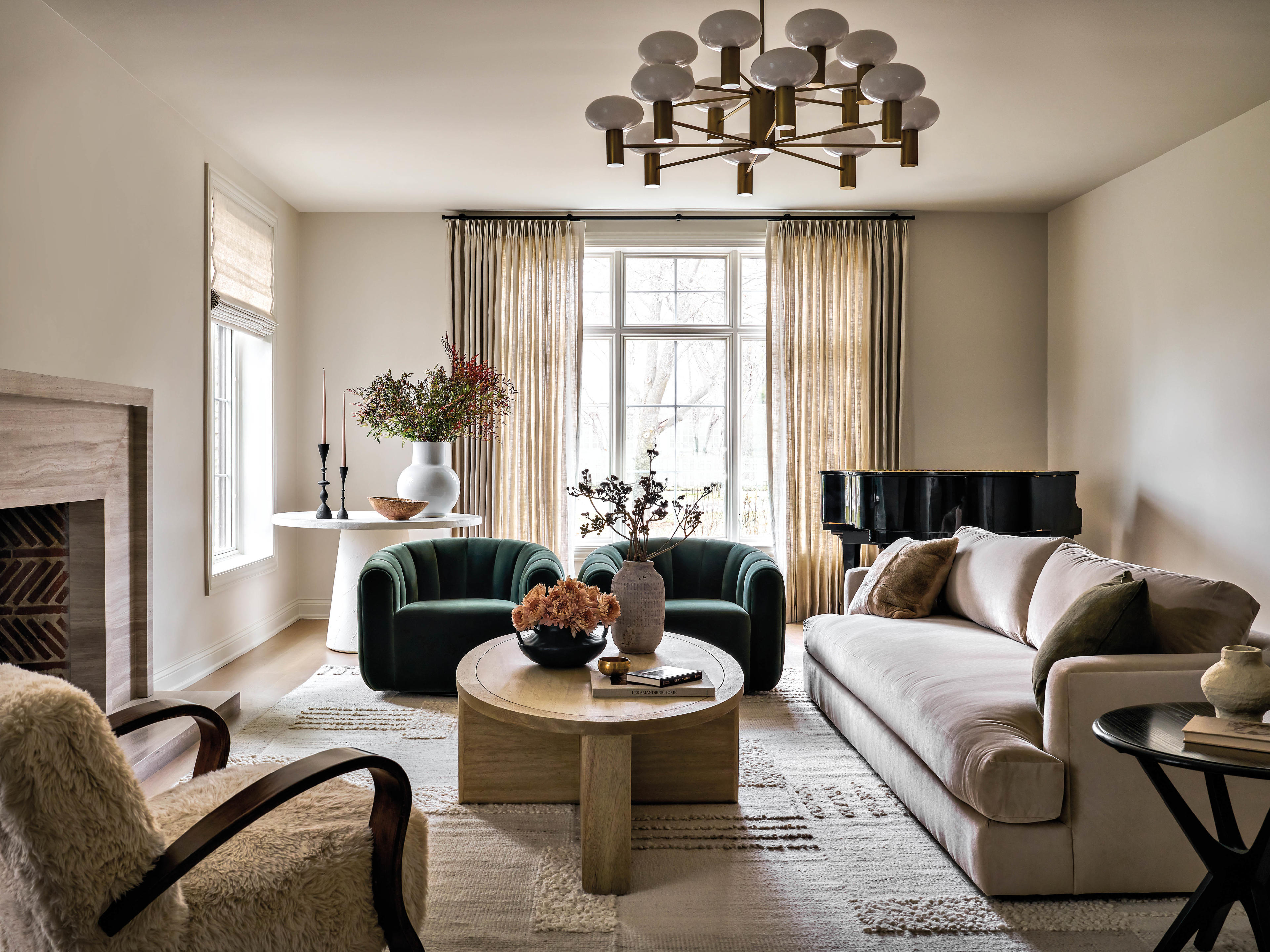 neutral California-style living room with a pop of color in two green armchairs