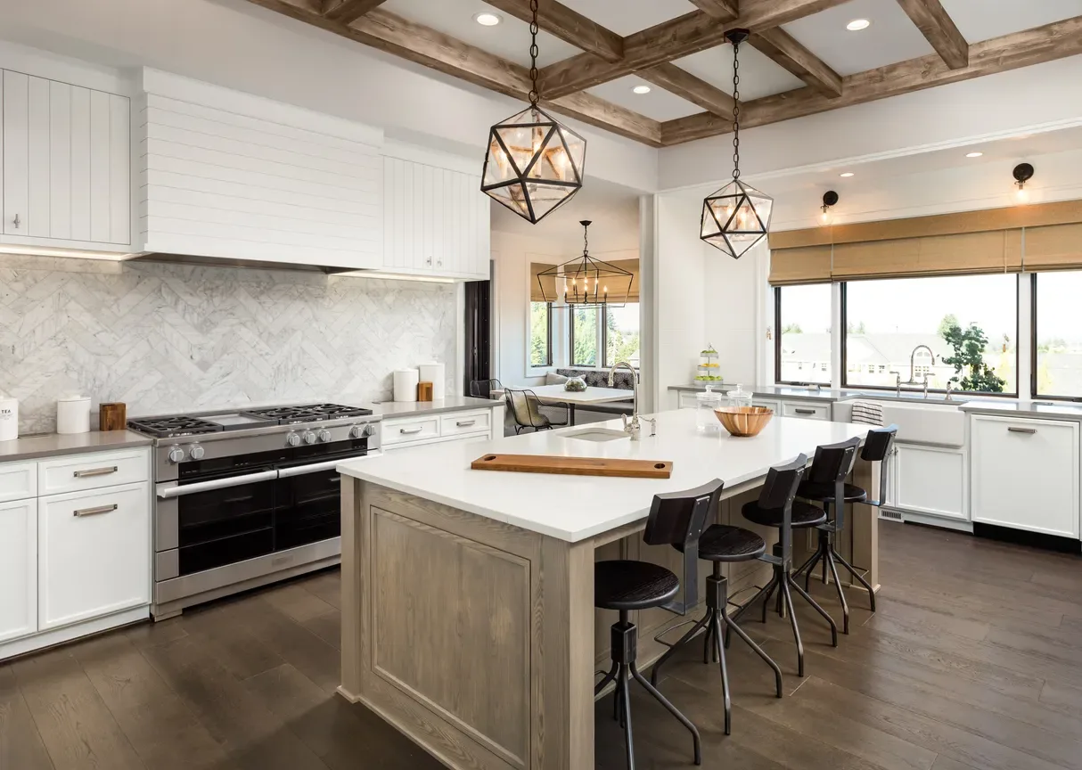 This custom kitchen design by North Dallas Renovations features neutral wood tones on the island and floor to compliment the coffered ceiling. 