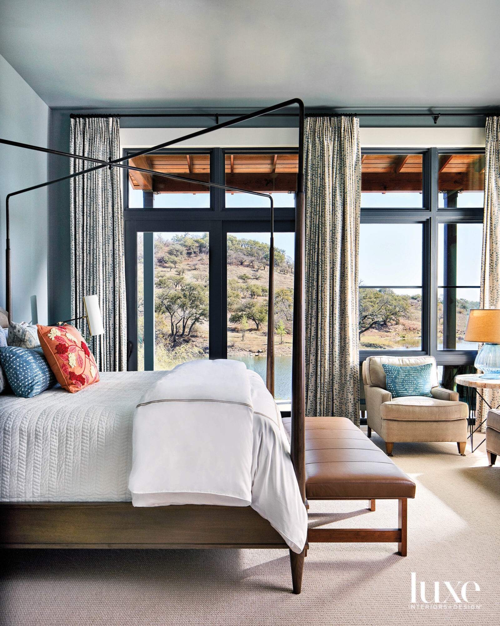 Bedroom with four-poster bed and expansive views.