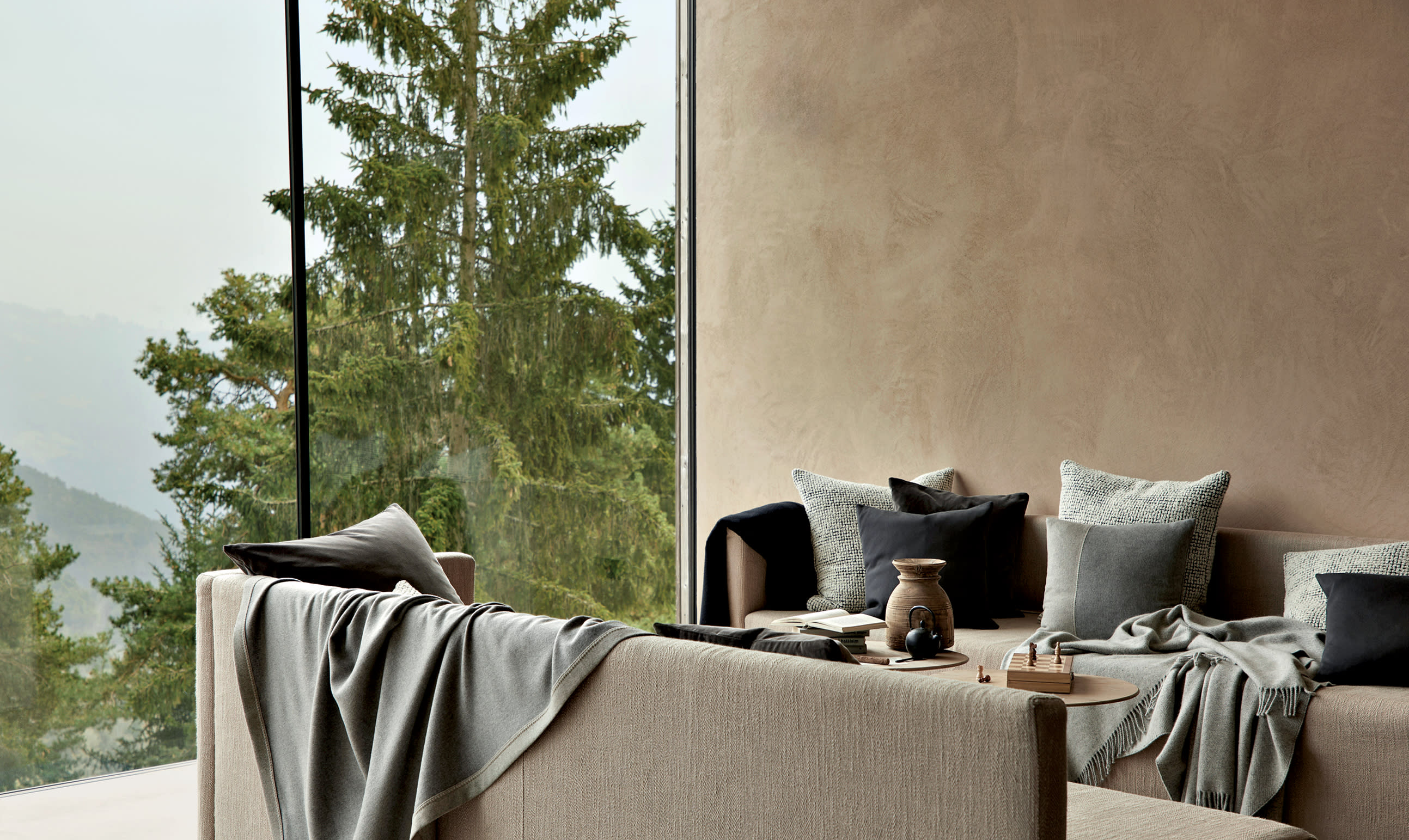 contemporary living room with lush blankets and throw pillows