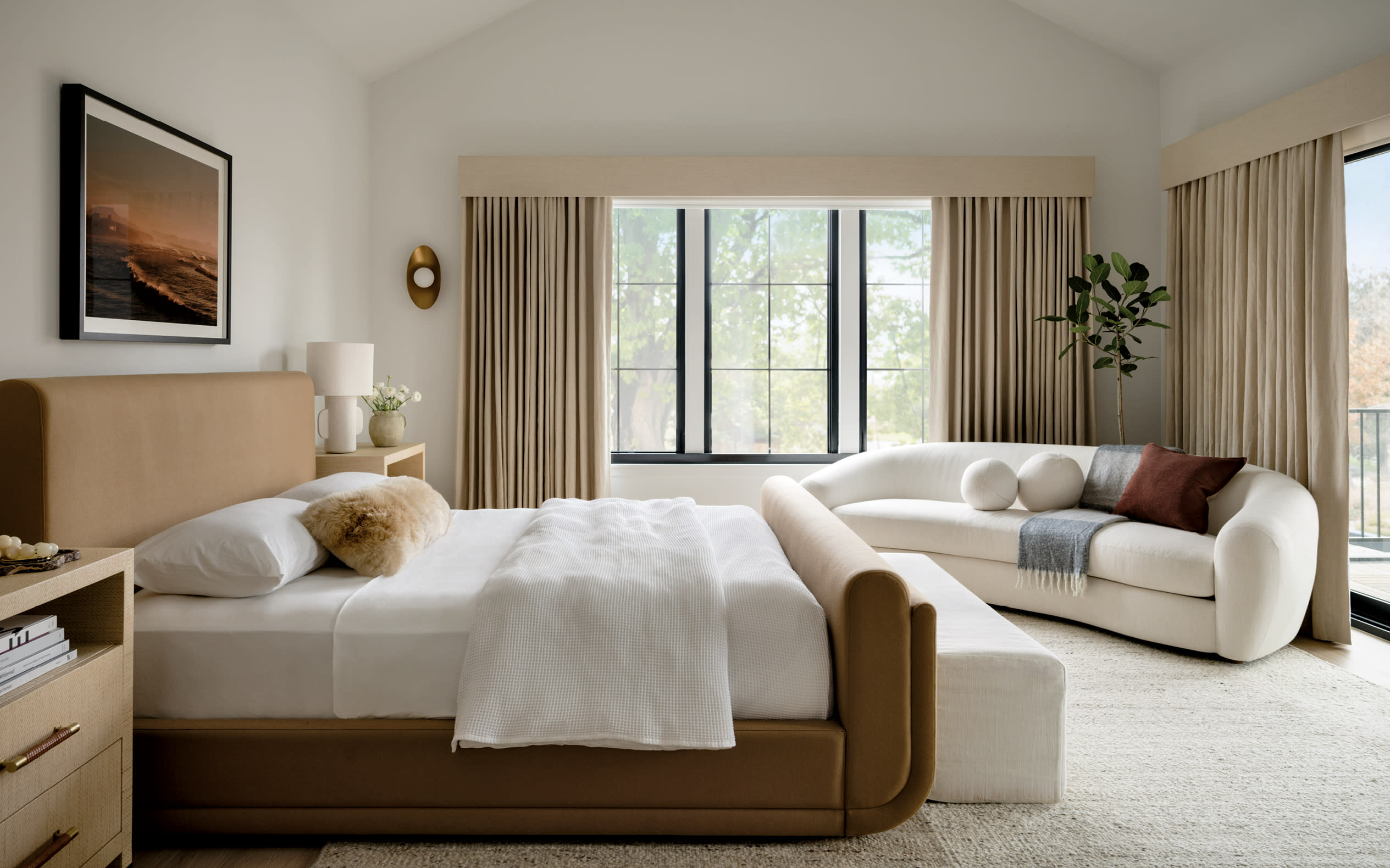 Scandinavian-style bedroom with a white sofa and a brown bed