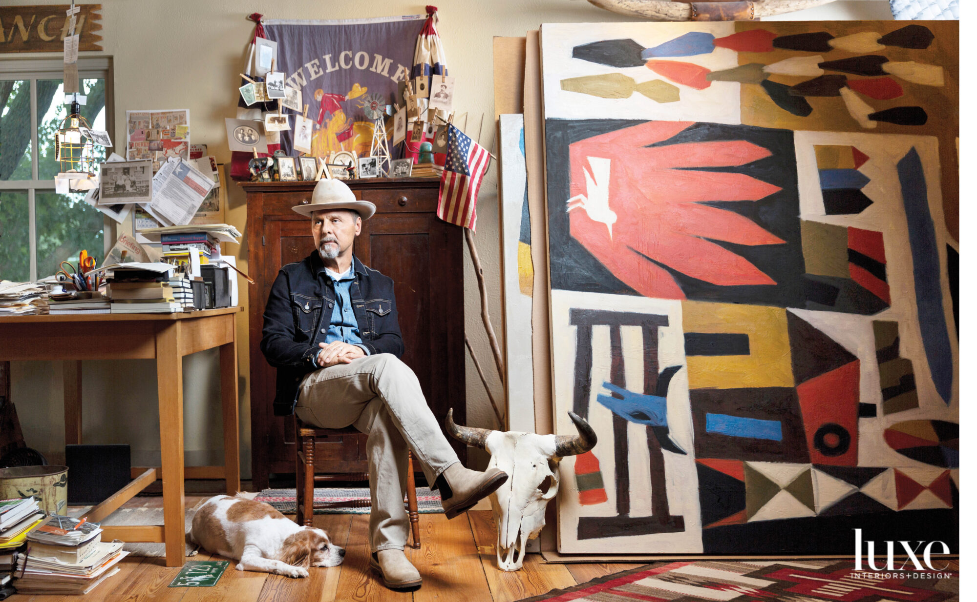 Artist sitting in studio with his dog.