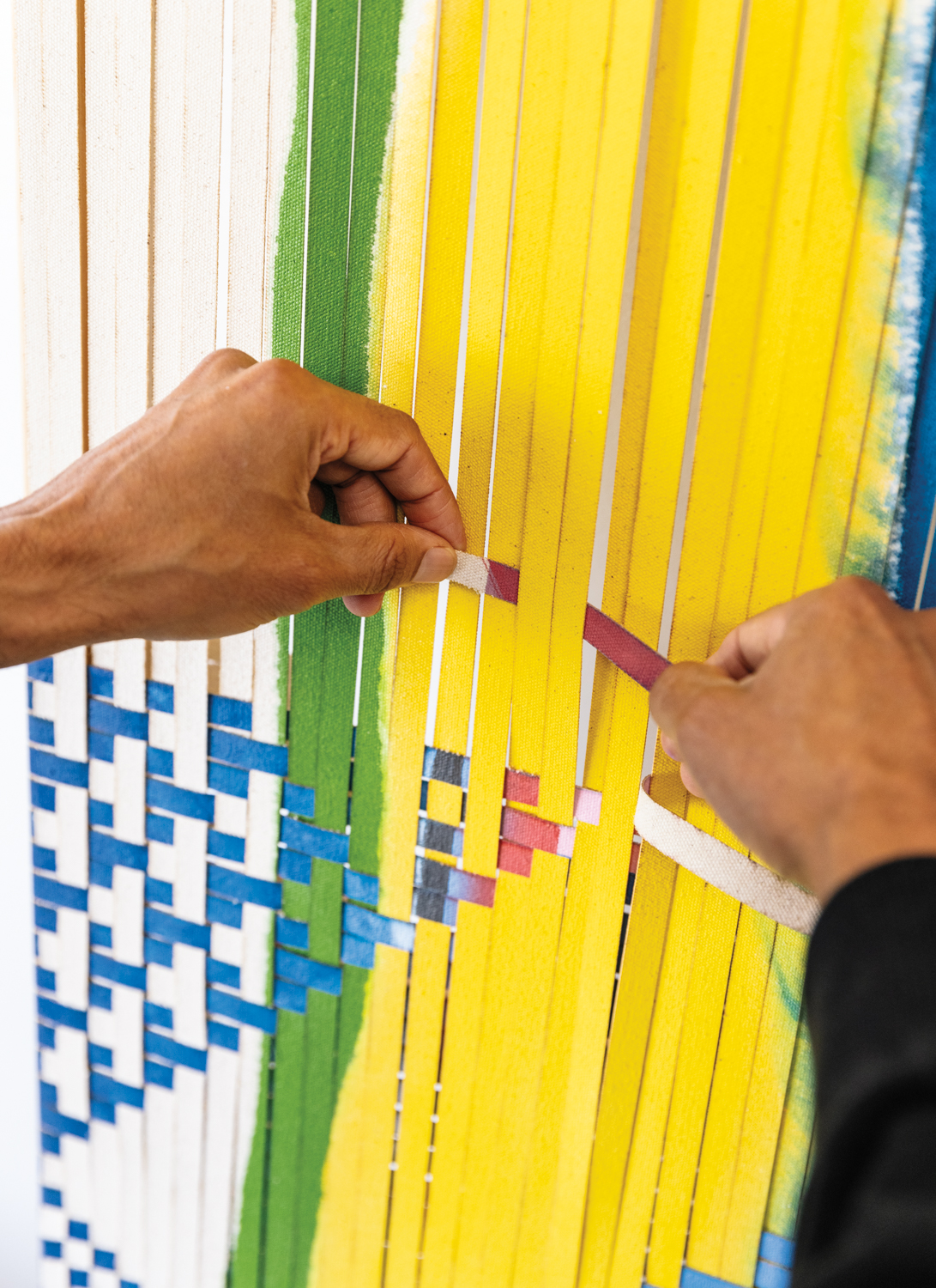 artist's hands weaving works