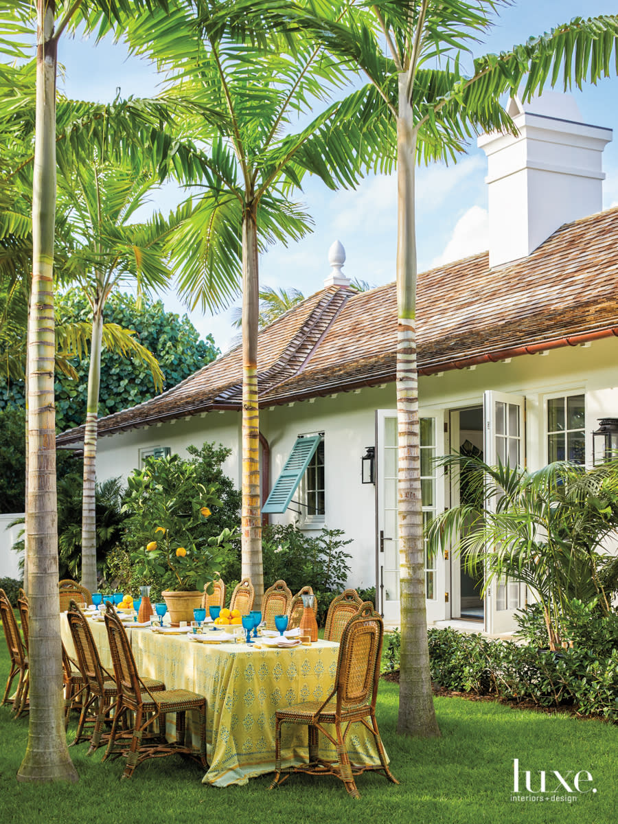 allee of montgomery palms with dining table