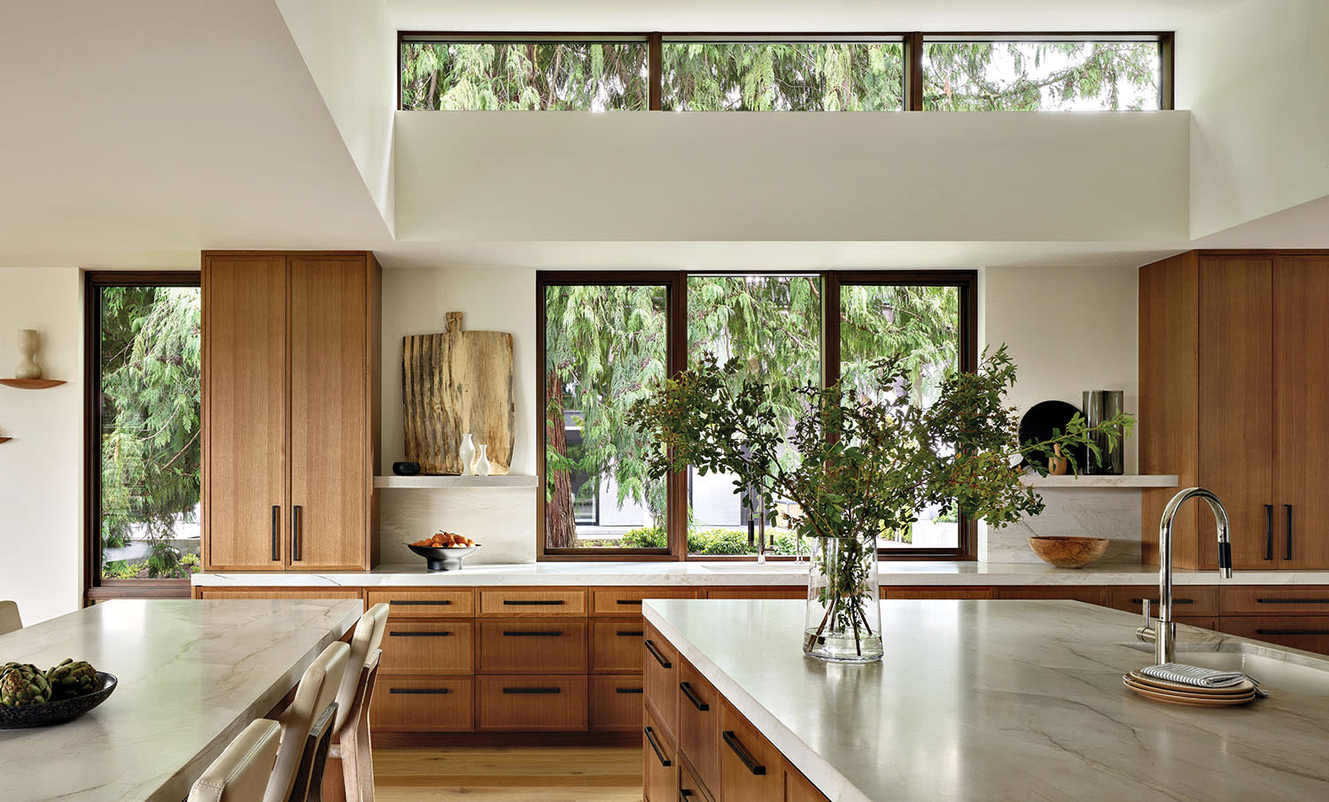 modern kitchen with a vaulted ceiling and oak cabinetry