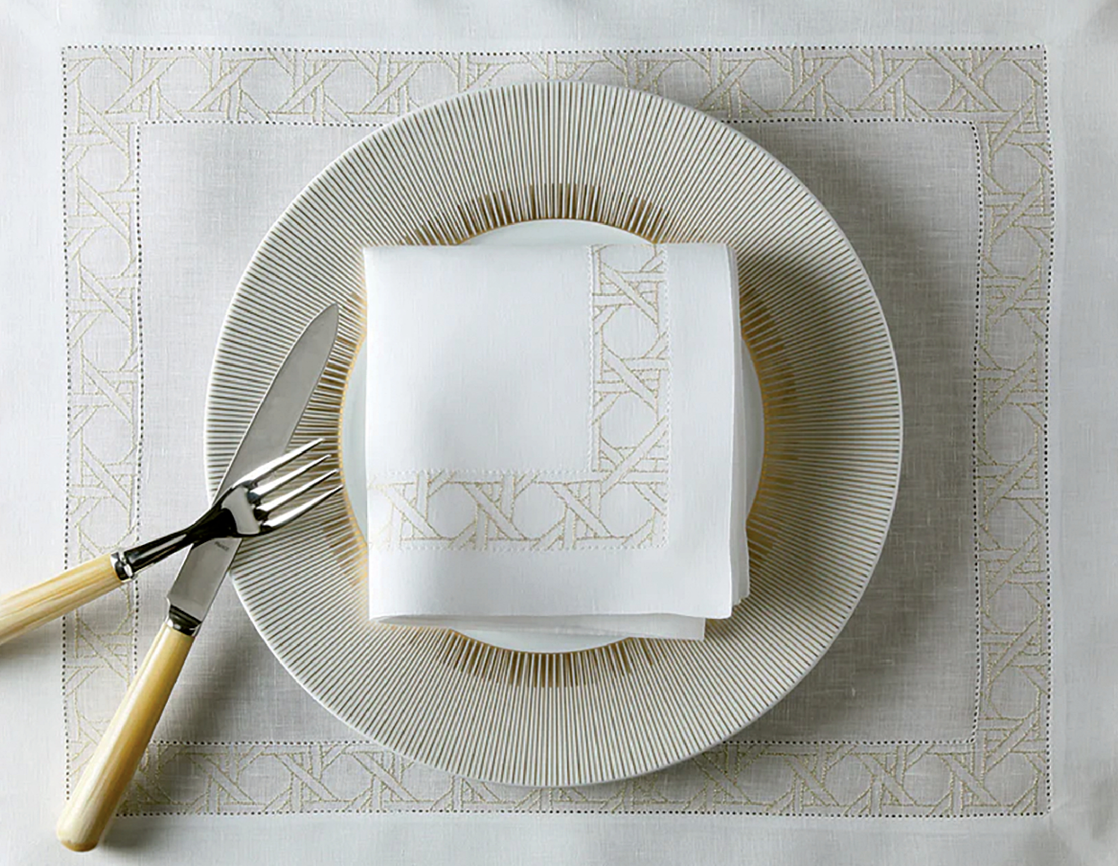 white textured plate on top of a linen placement and matching napkin