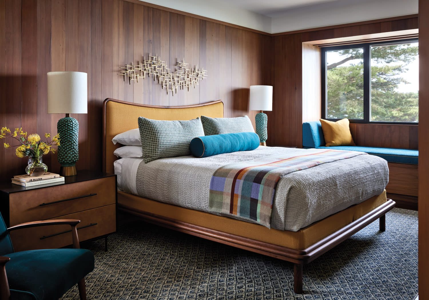 bedroom with wood paneling and midcentury furnishings