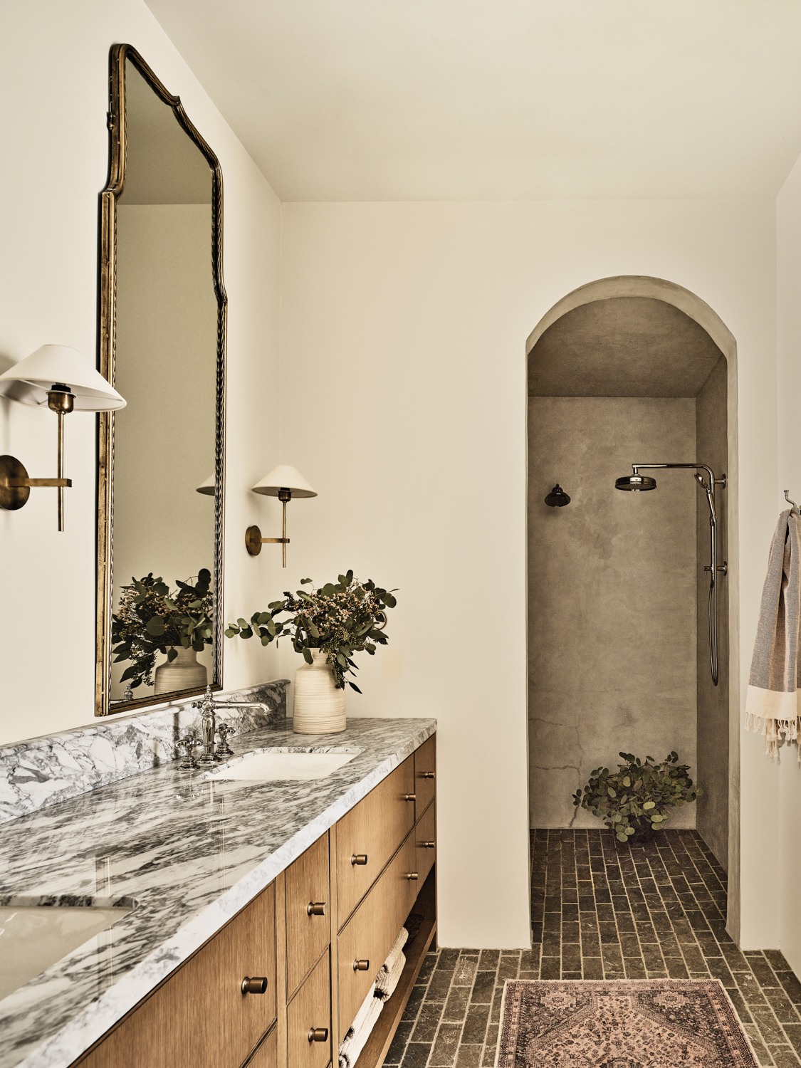 wellness room with marble countertops, white pointed wall sconces and arched doorway