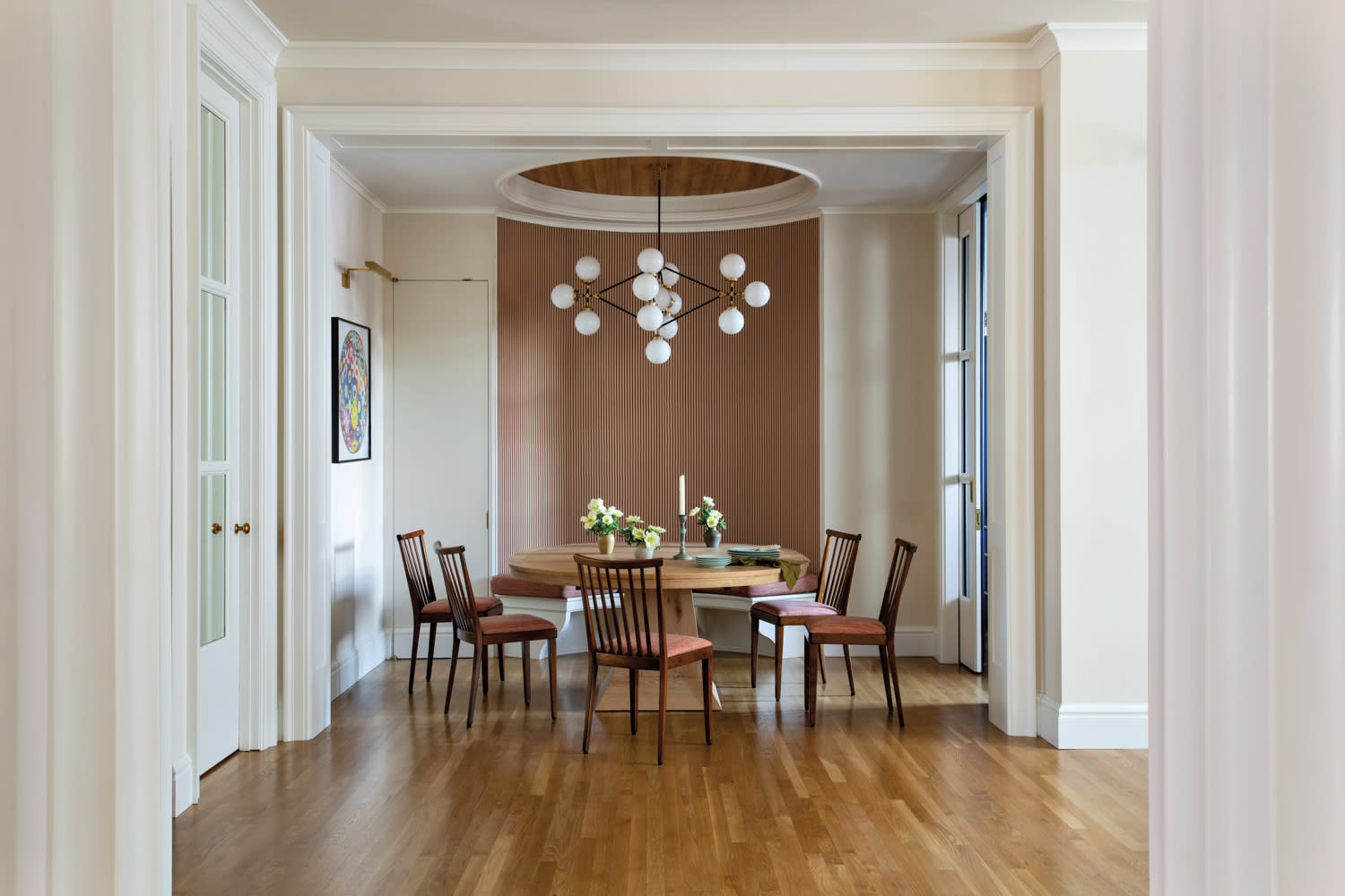 dining nook with vintage chairs and a globular pendant light