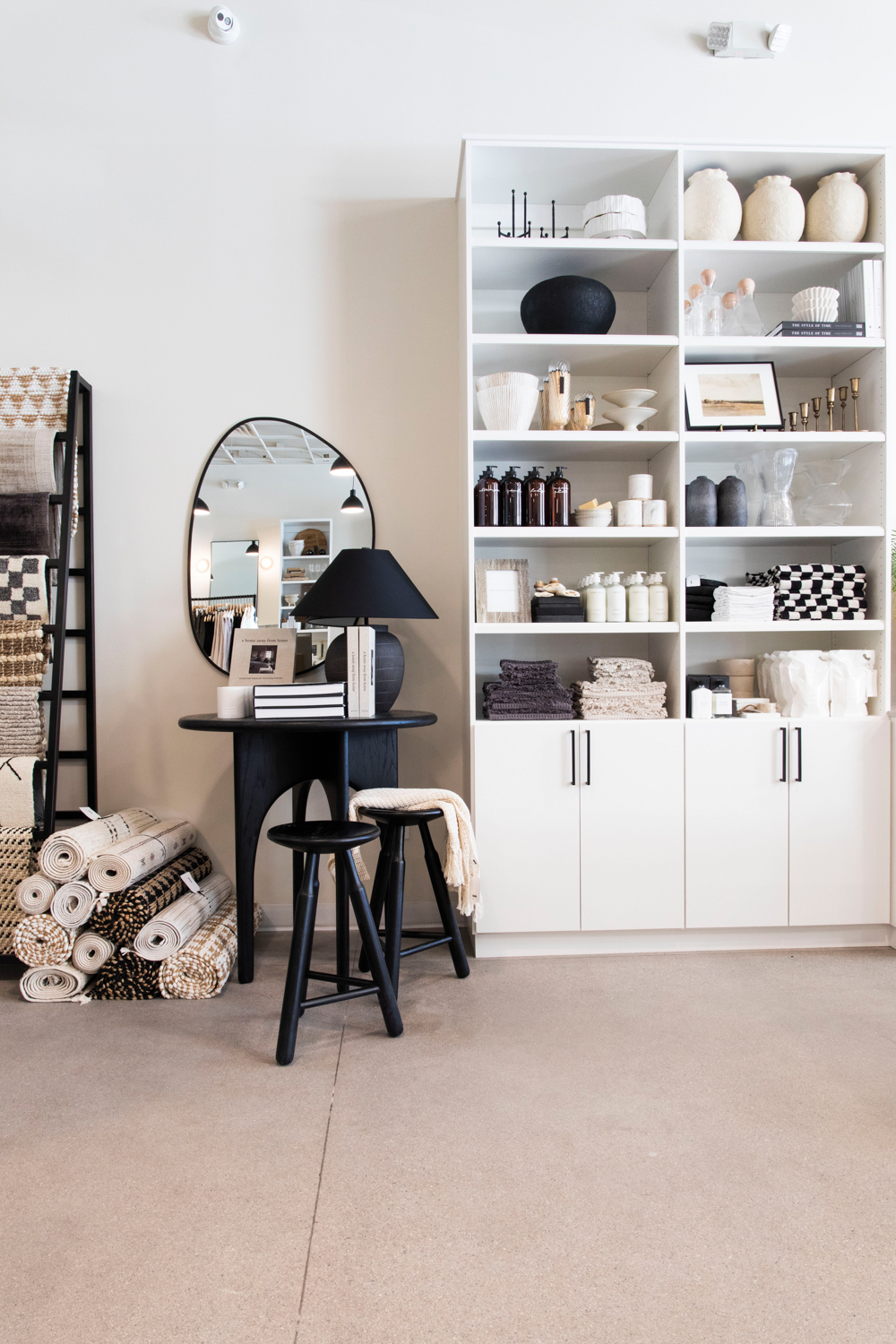 Section at TheLifestyledCo displaying rugs, vases and other objects in a neutral palette