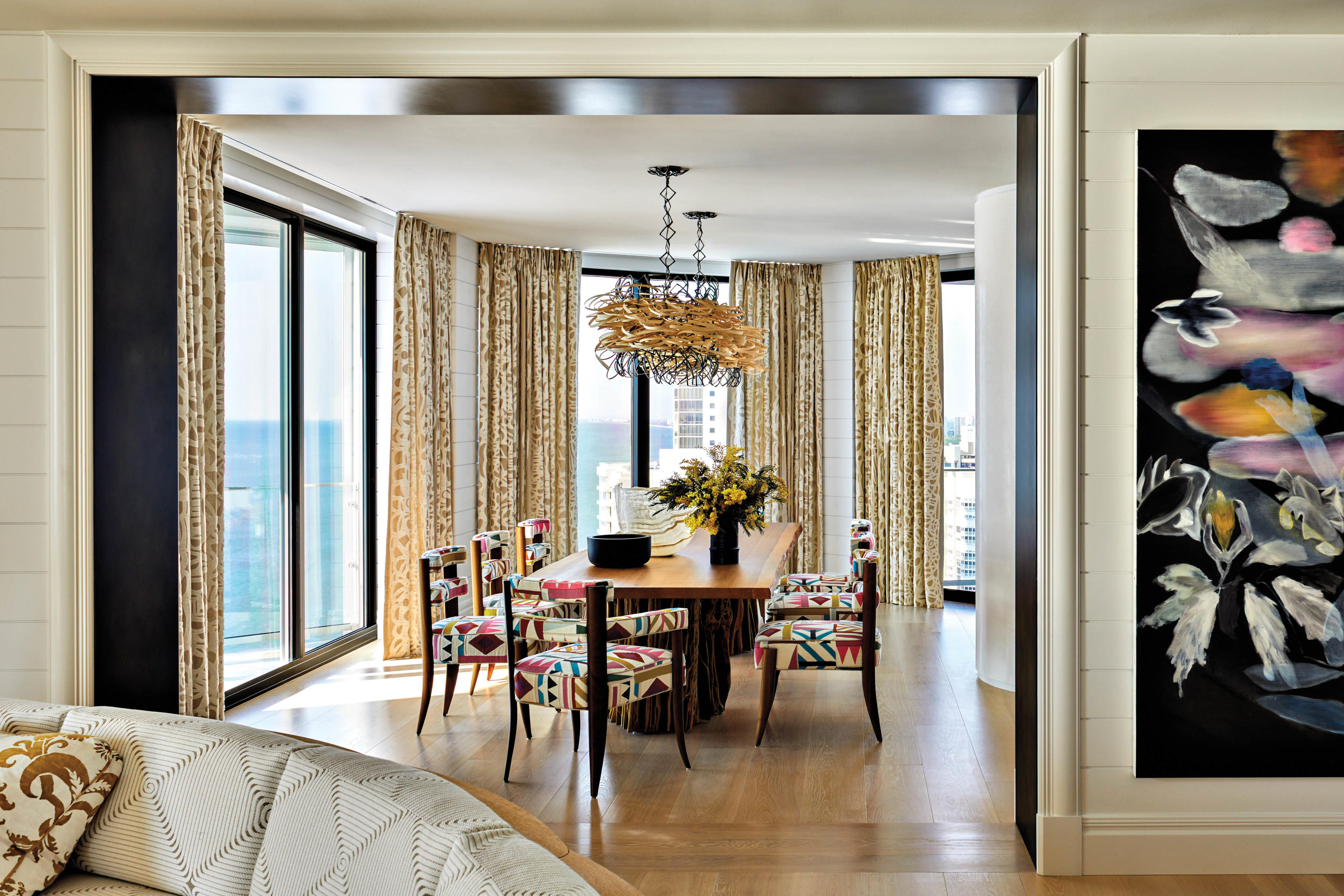 modern dining room with dining chairs upholstered in a bright geometric fabric