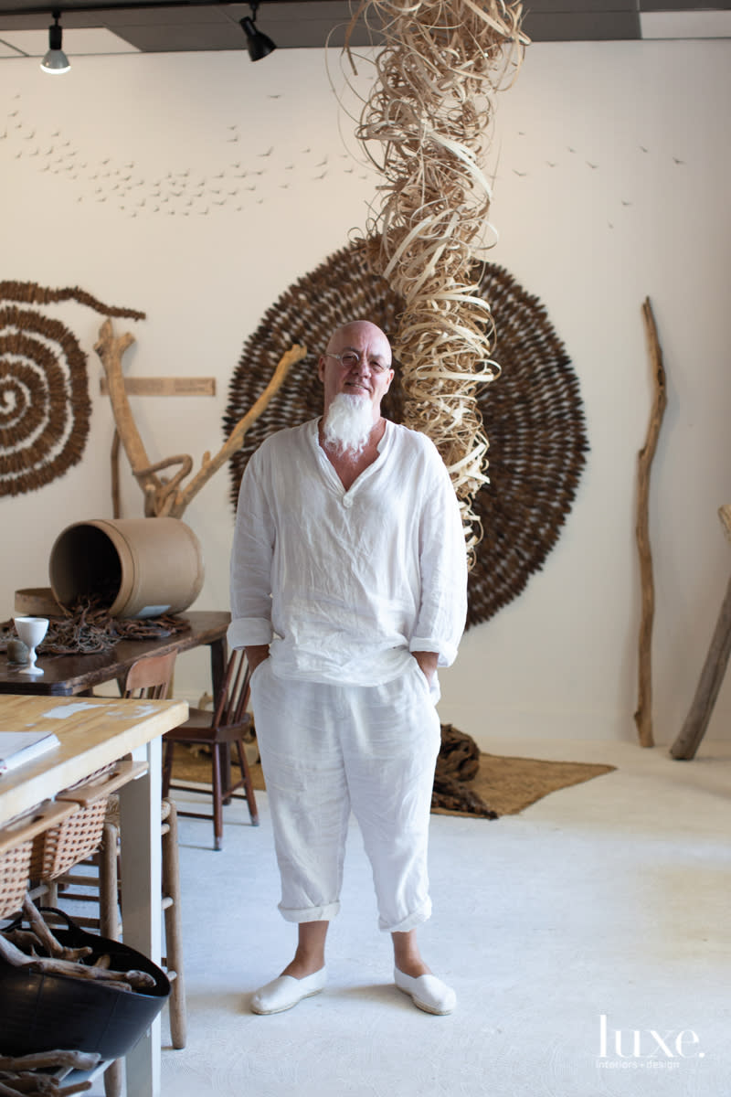 ran adler in his studio with pieces of wood art