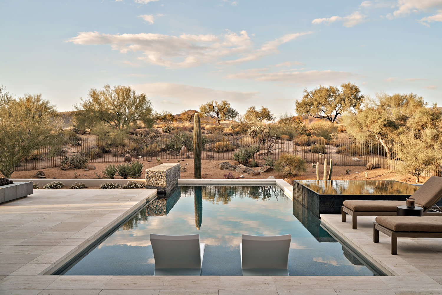 pool area with travertine deck tiles featuring views of the Arizona desert landscape
