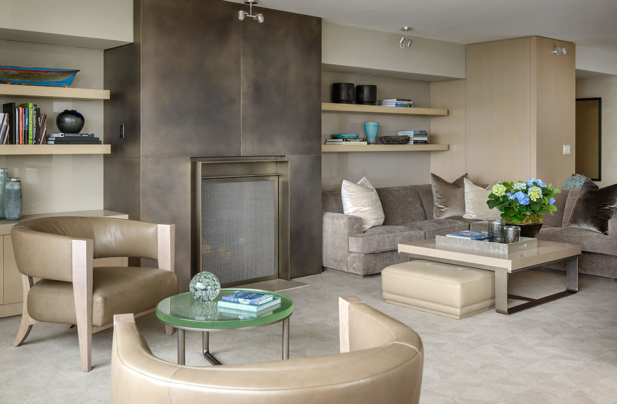 Custom Fireplace, Stone and Nickel Coffee Table and Cast Glass Occasional Table. Designed by Lucas Interior.