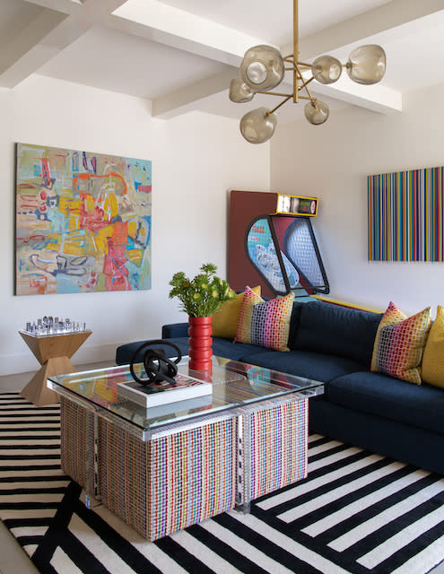 A vibrant rug lies on the floor, adding a burst of color to the room's decor.