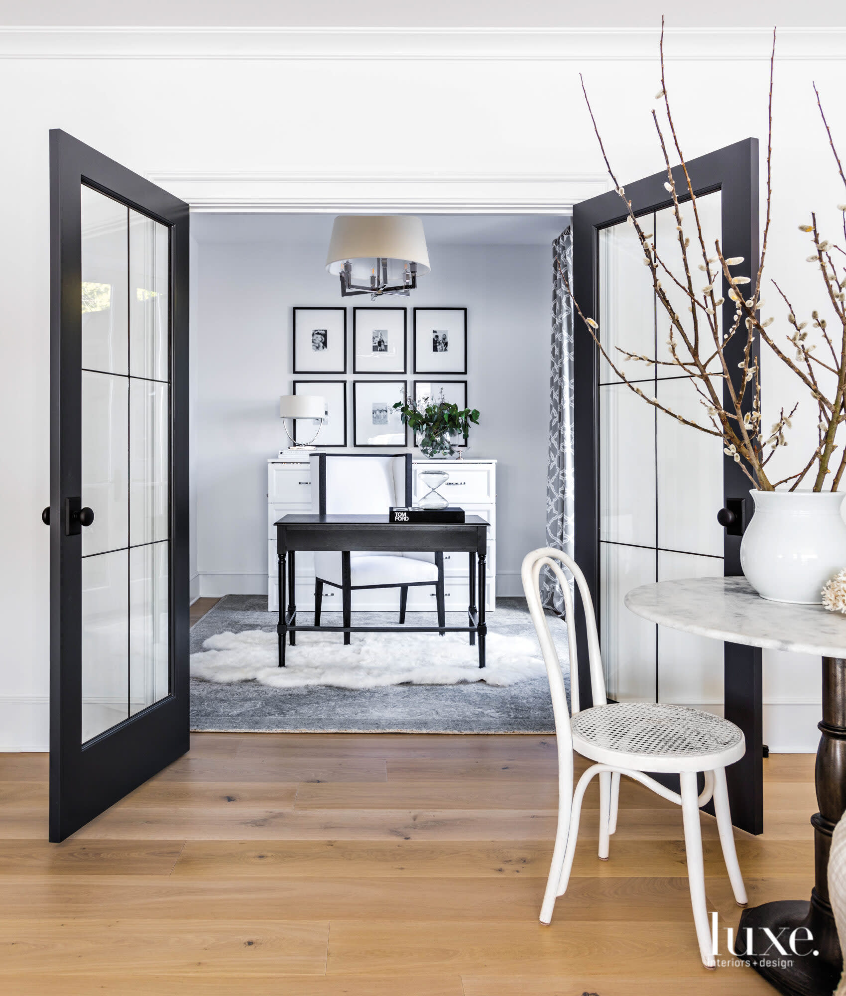 Home office with pencil desk and cabinet behind disguising a murphy bed