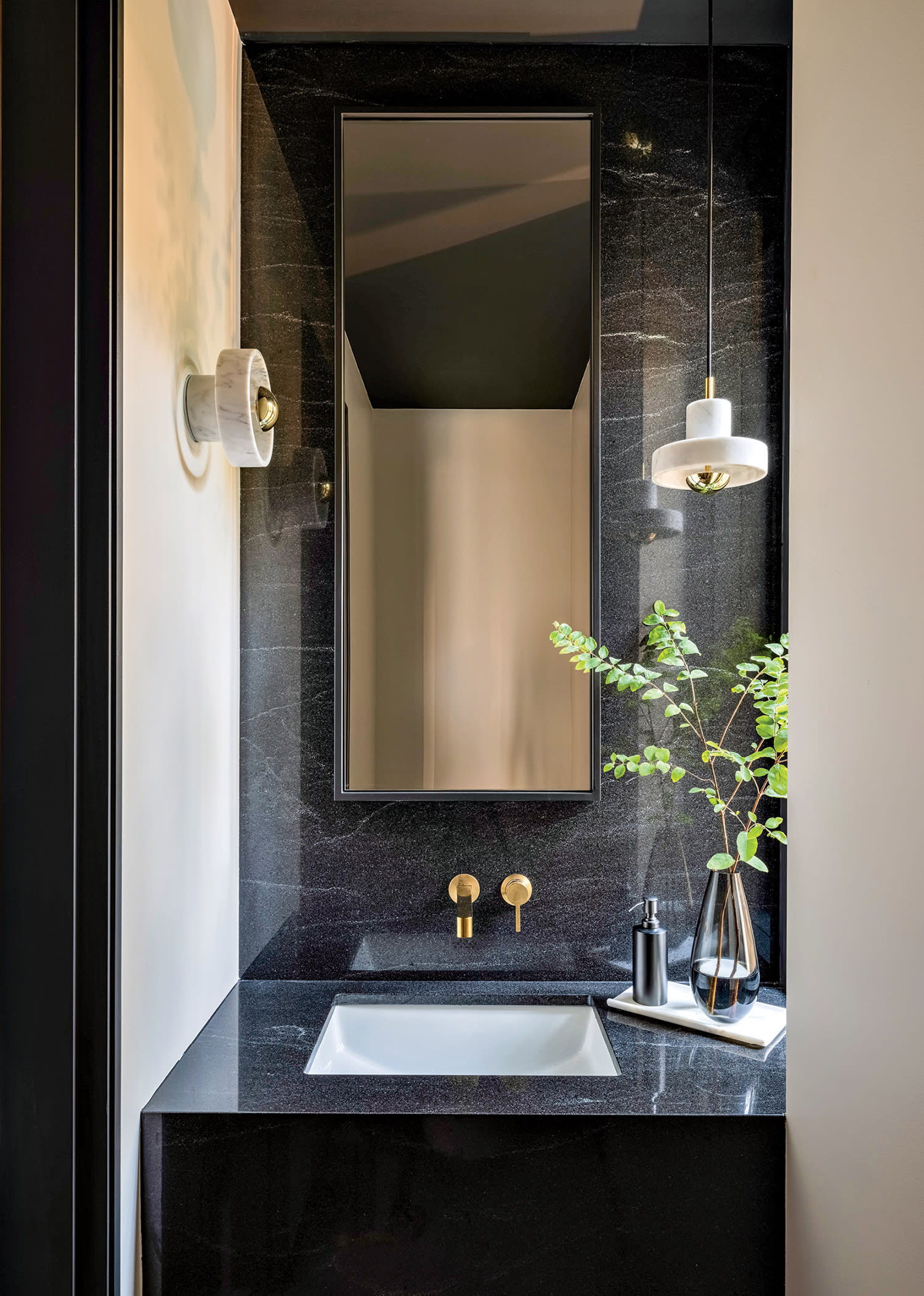 powder room with a black granite vanity
