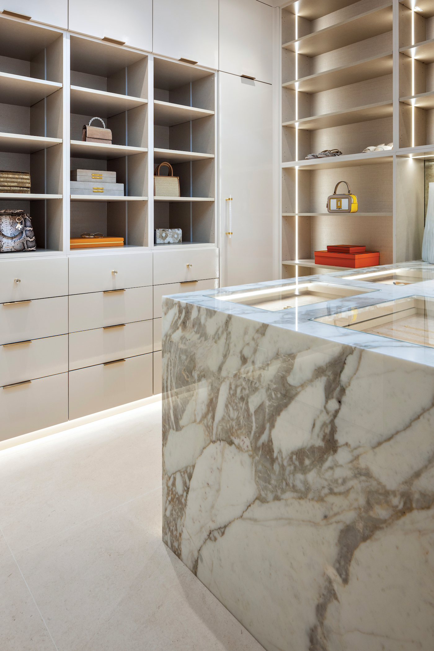 Bathrooms and closets featuring high-end marble surfaces and custom stone installations.