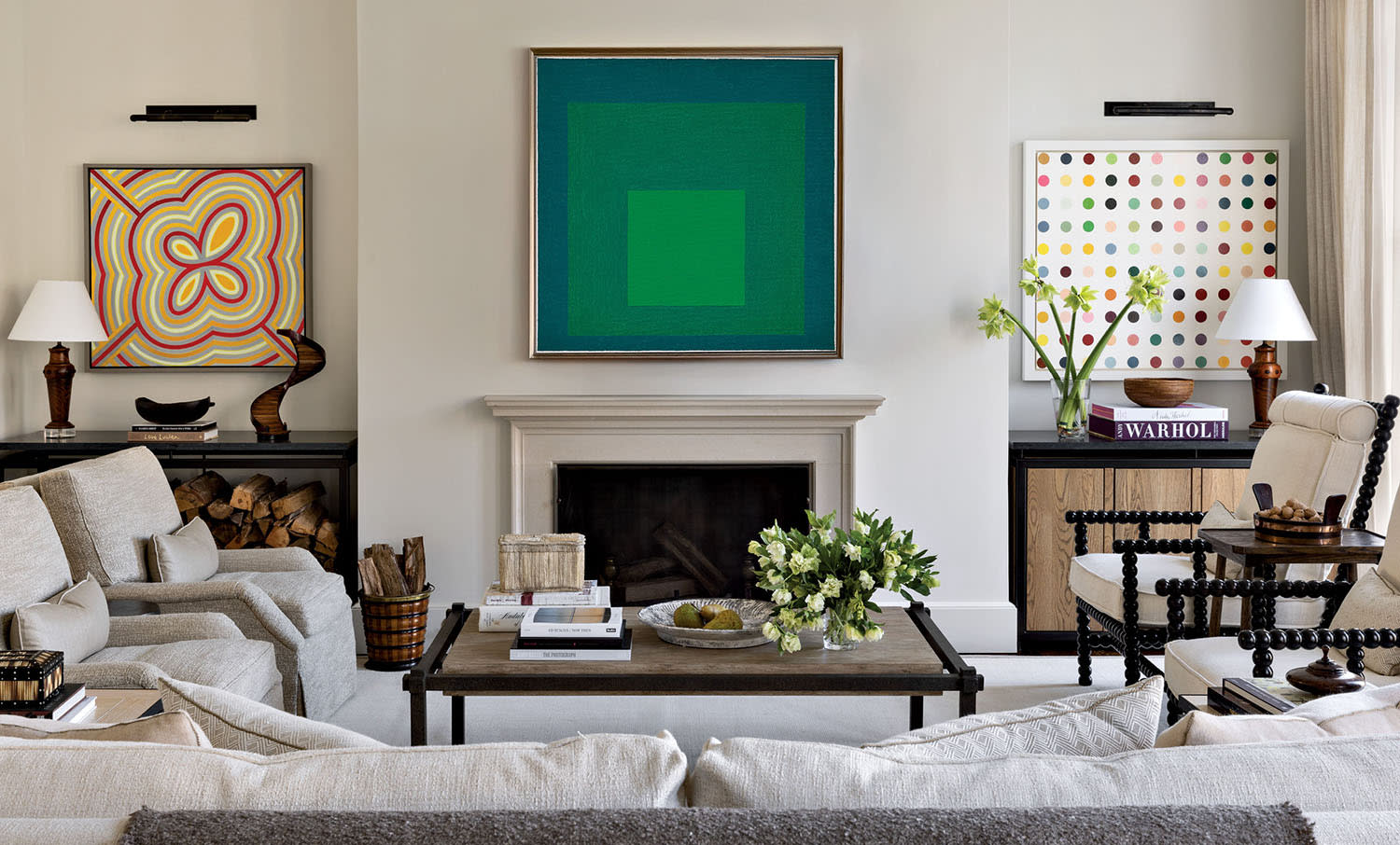 traditional family room featuring a green artwork above a fireplace