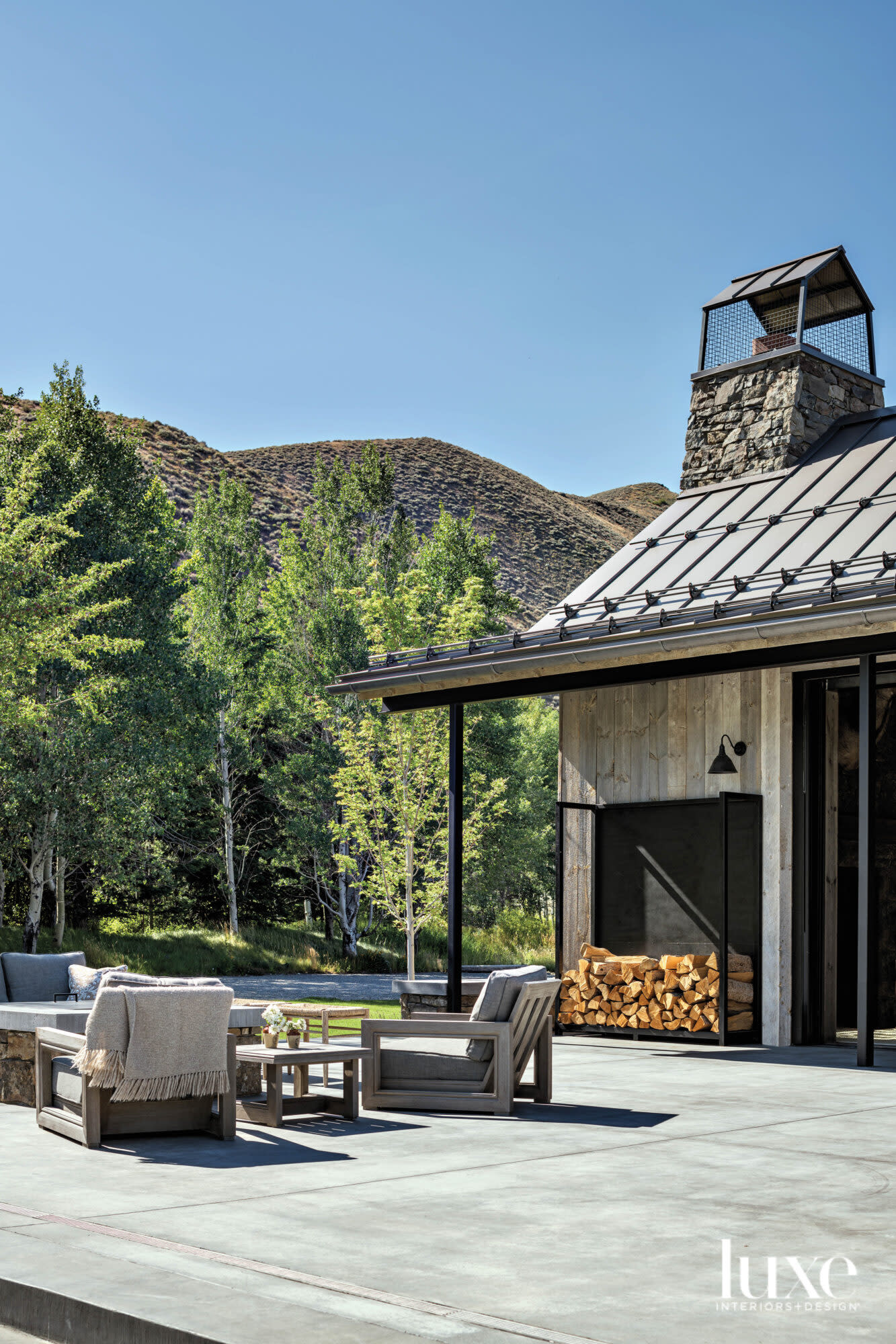 Exterior patio with furniture around fire feature