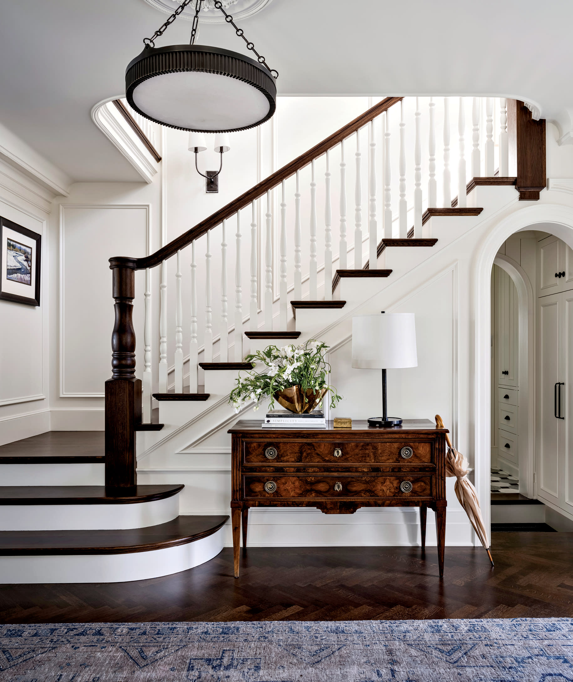 traditional entryway with a grand staircase and an antique console