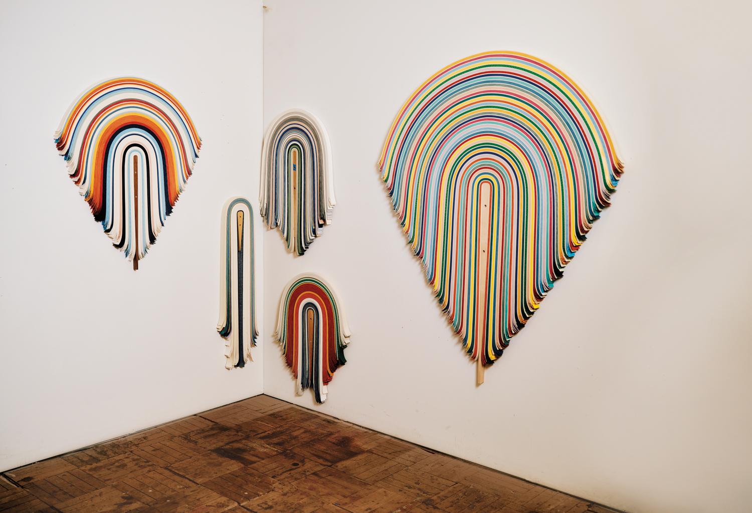 series of draped vinyl sculptures hung on wall