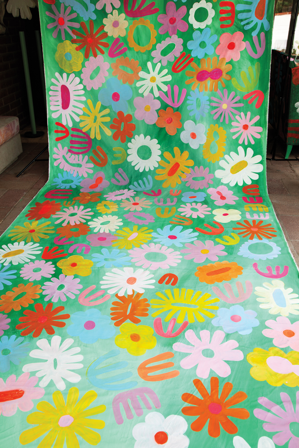 Long brightly colored flowered painting in green, yellow, pink, orange and blue.