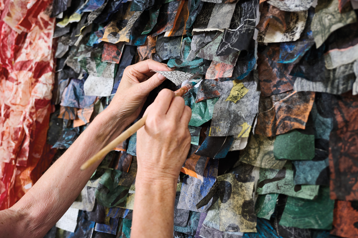 Eva Isaksen adjusts her large-scale piece