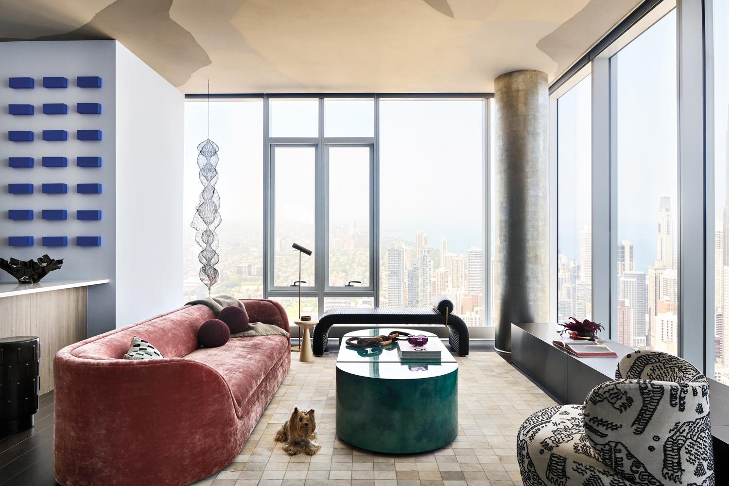 living room with pink sofa, green coffee table and black-and-white swivel chair