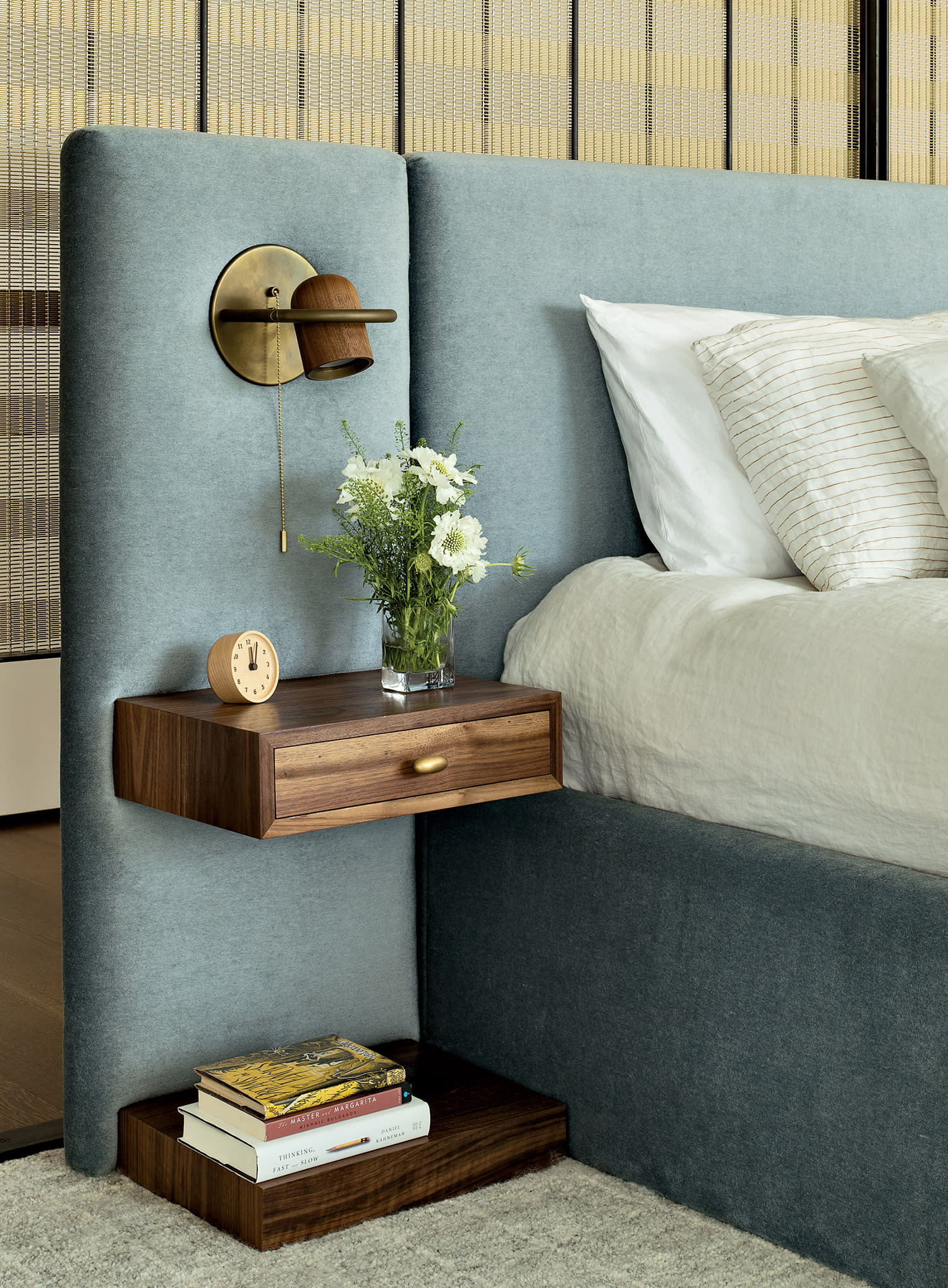 primary bedroom with a Coraggio mohair-upholstered headboard, walnut tables and an Allied Maker light