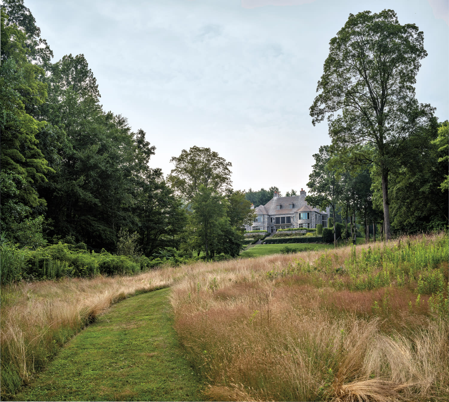 overgrown green landscape and english manor house