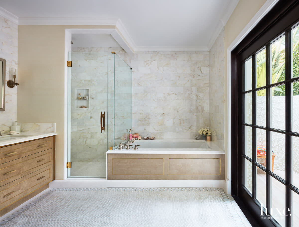 master bathroom with tile flooring and tile walls