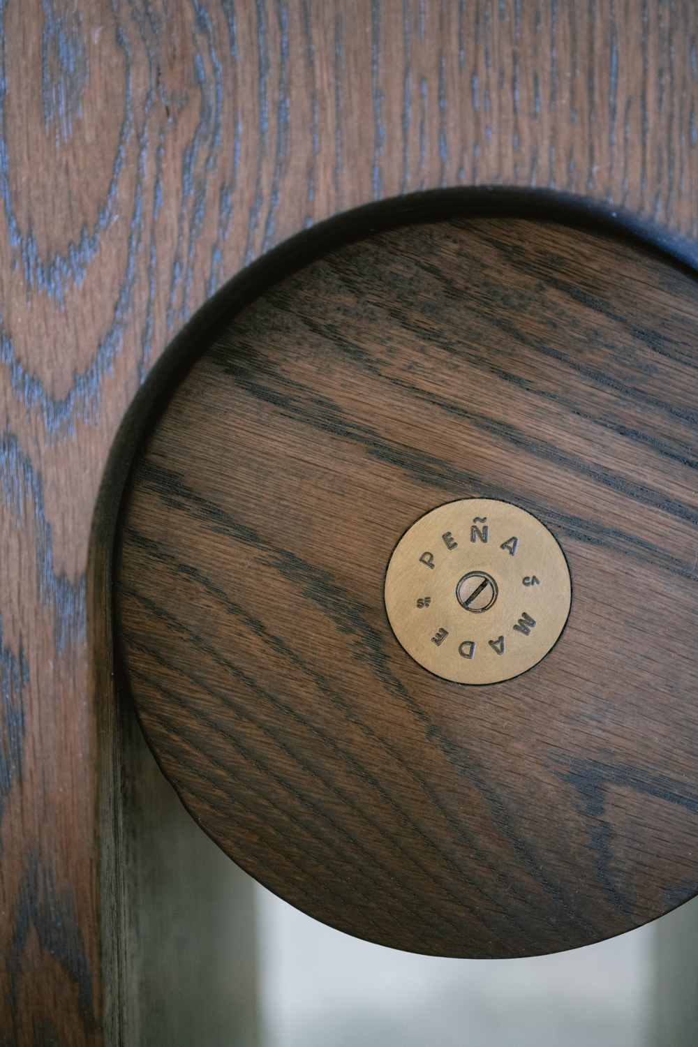 wooden piece of furniture with brass circle marker