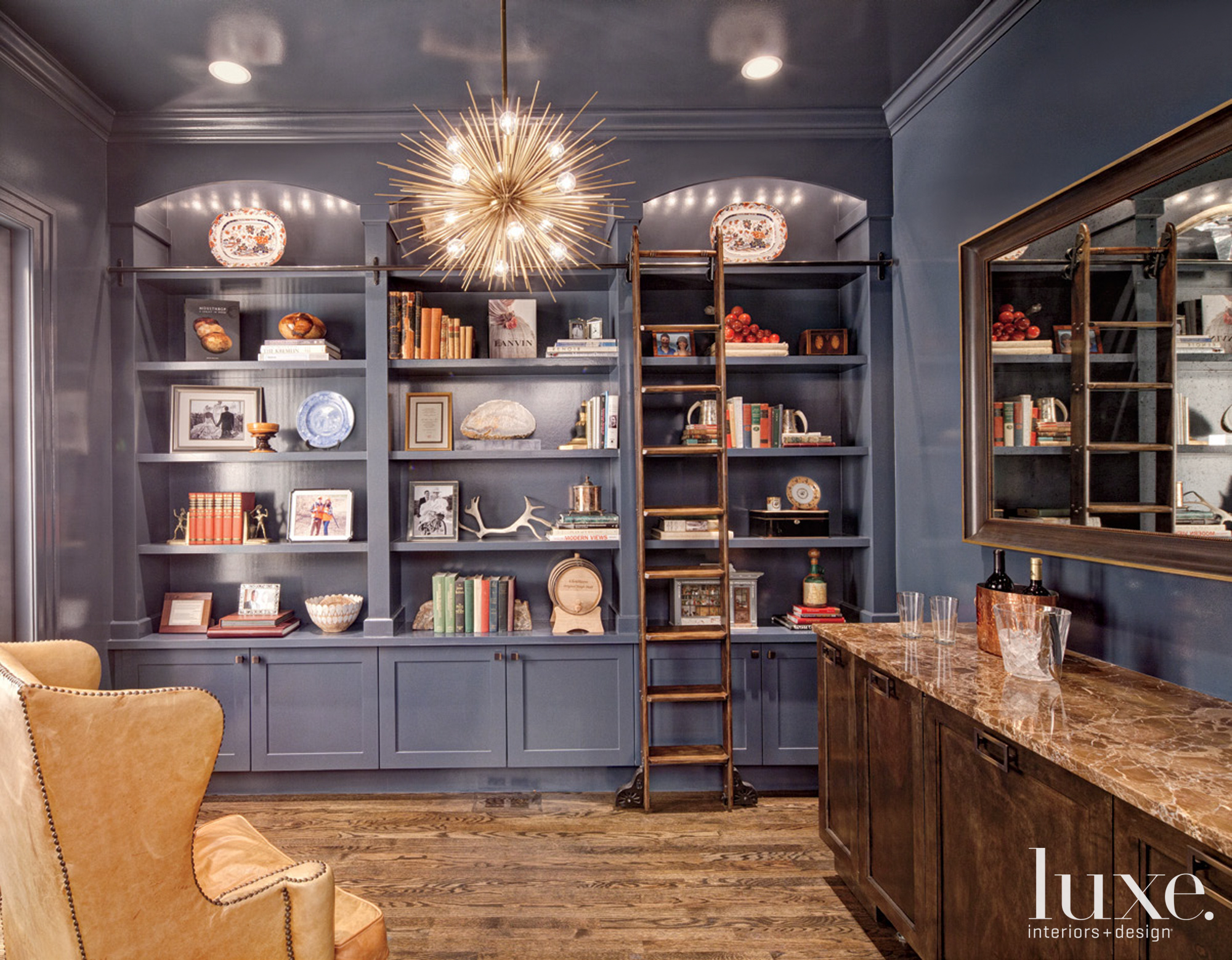 black shelves and spherical chandelier in library