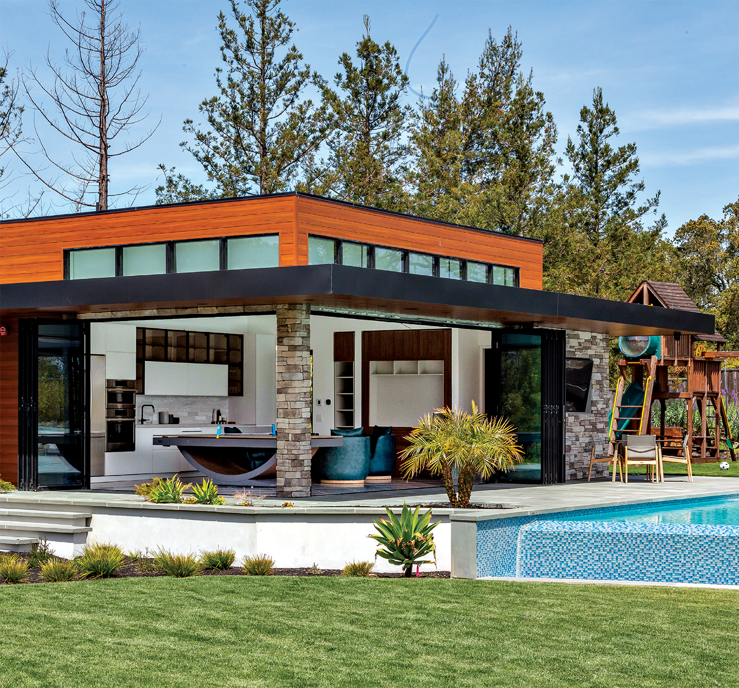 exterior of a modern Saratoga home with expansive glass walls open to the backyard