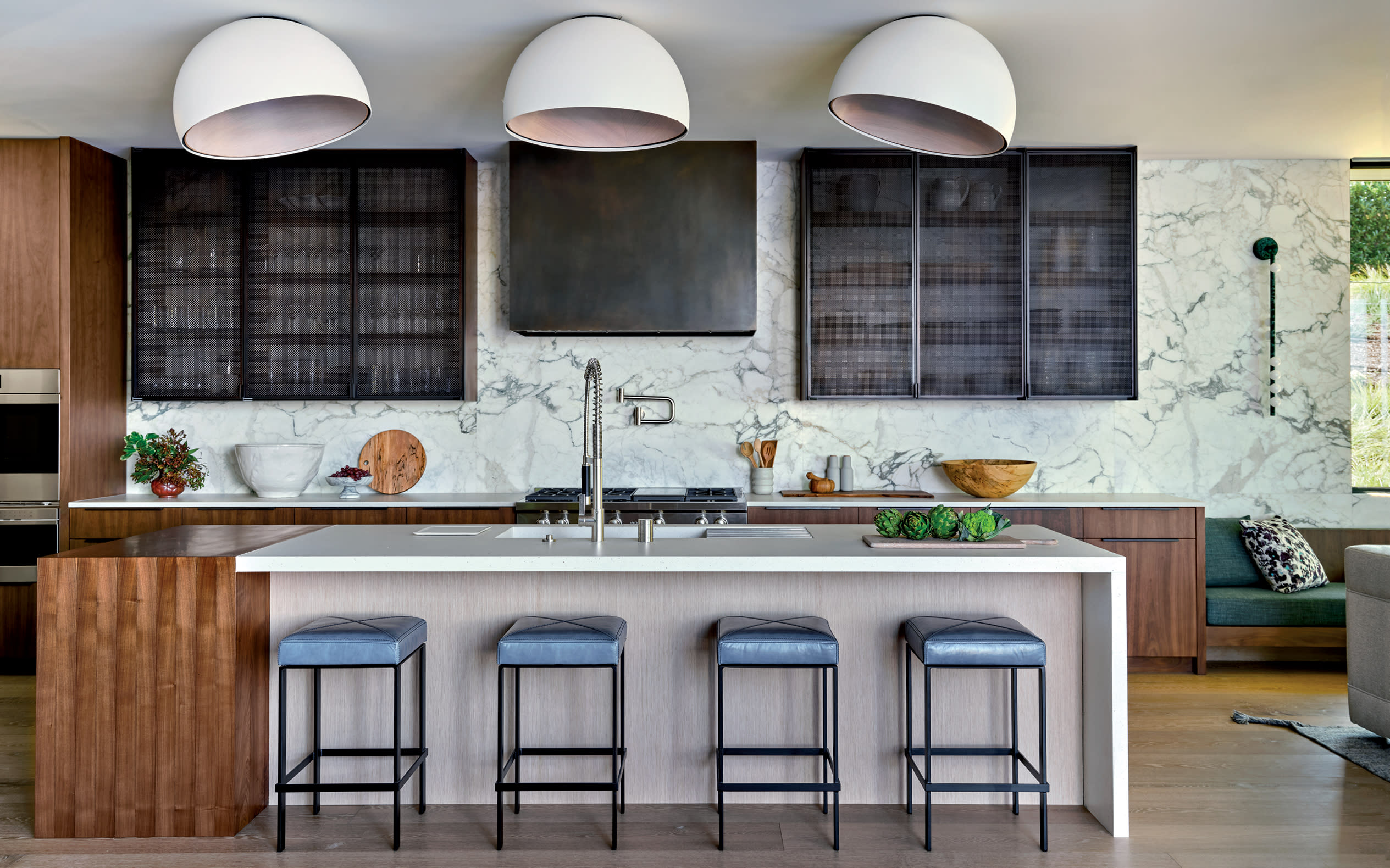 transitional kitchen with oversize fixtures over the walnut-and-riftsawn-oak kitchen island