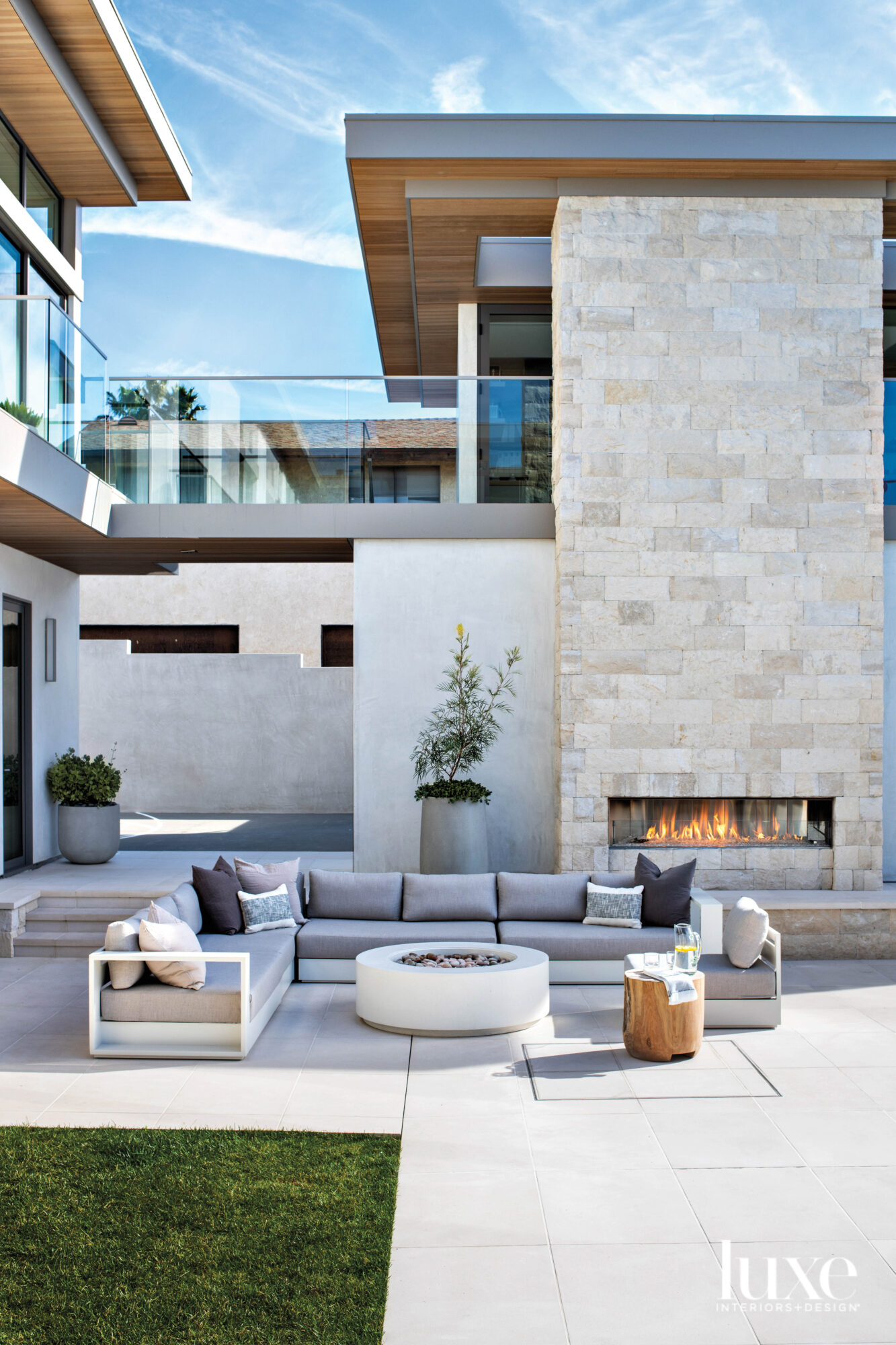 Outdoor terrace with large sectional and fireplace and fire feature