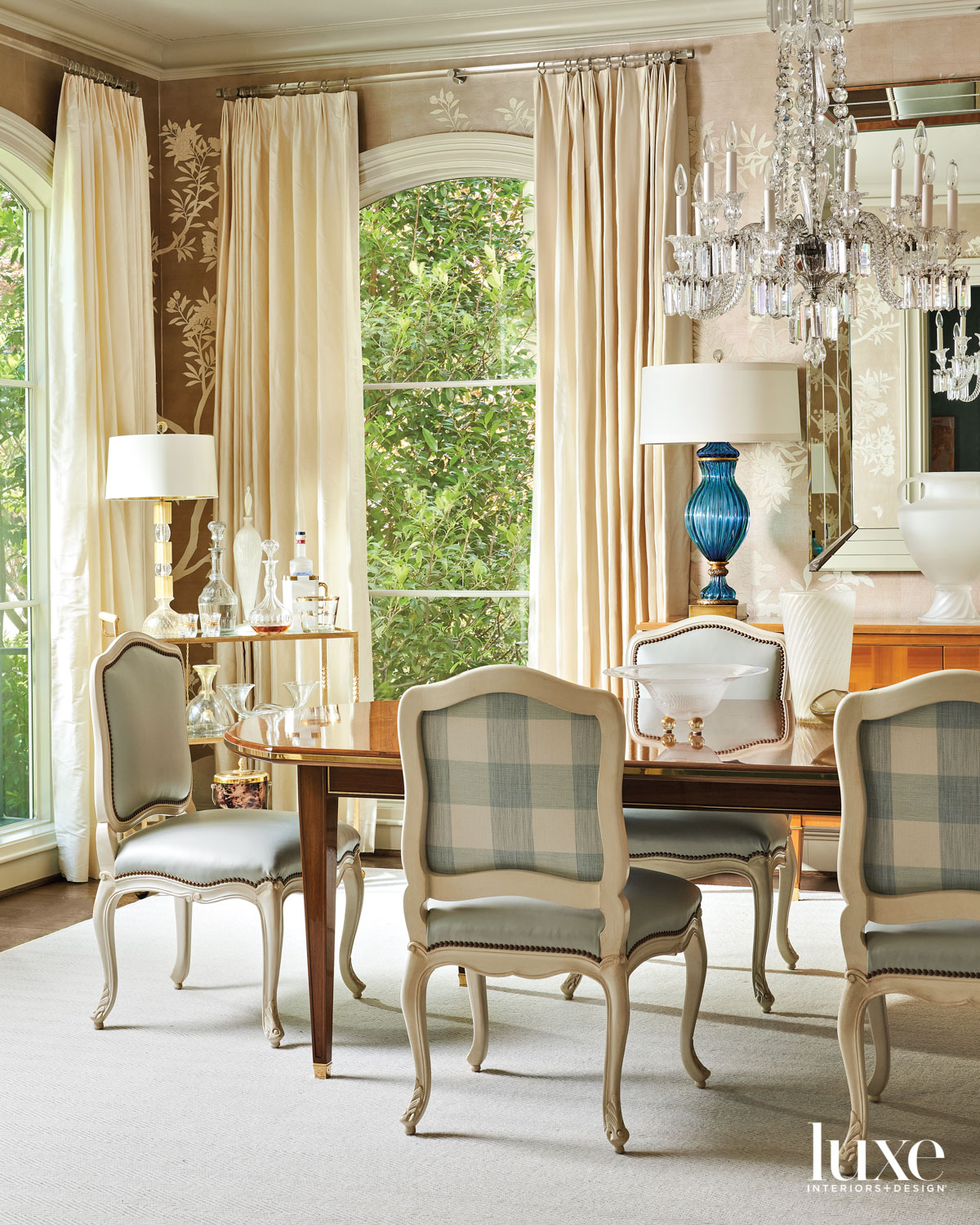 dining room with hand-painted wallpaper, a crystal chandelier and traditional chairs