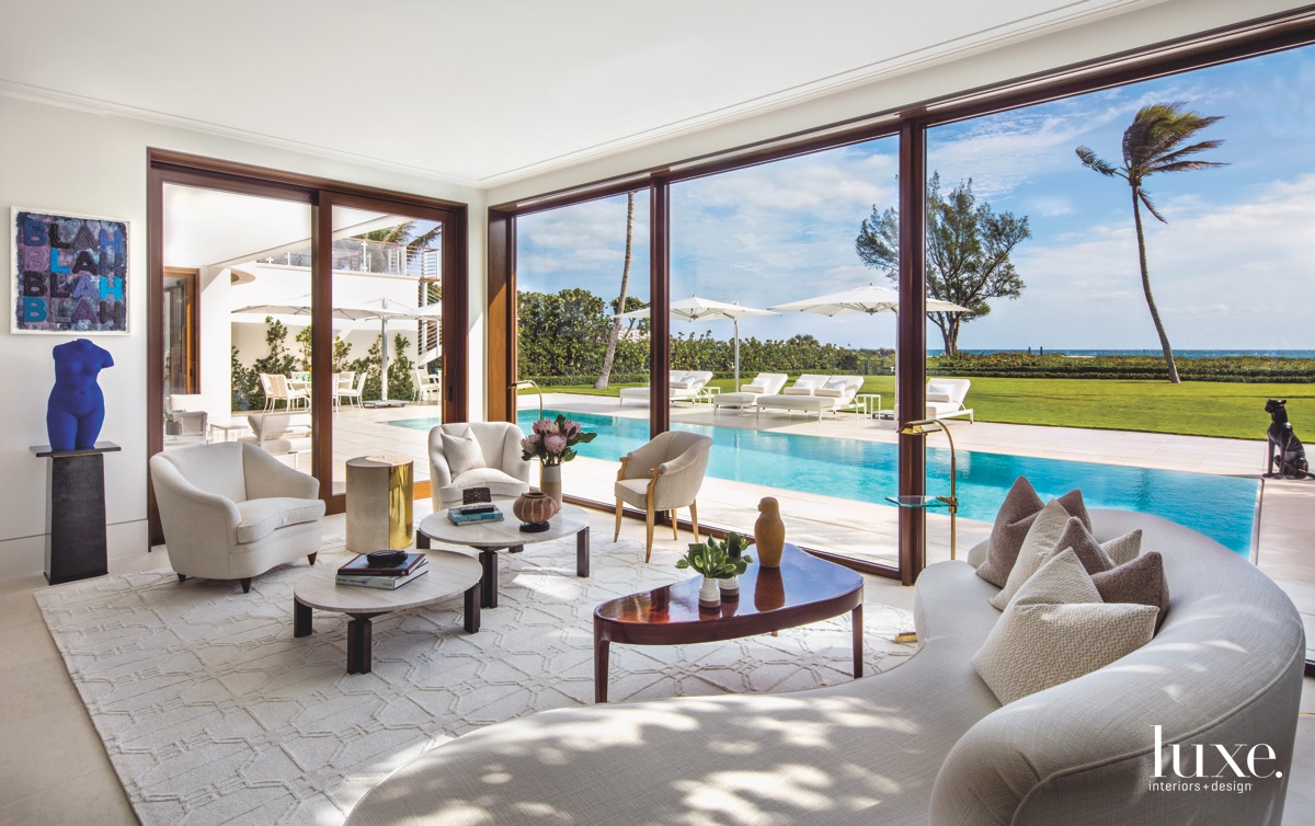 modern living room curved sofa view of pool