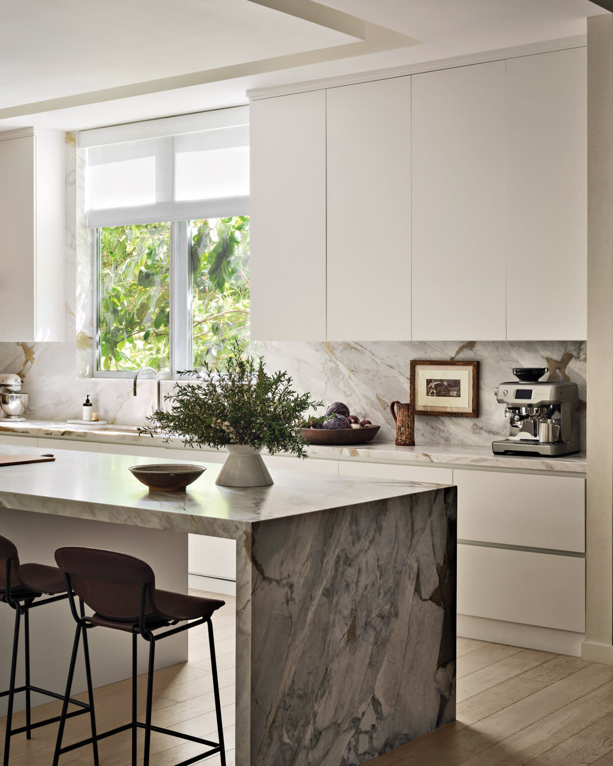 gray marble kitchen island and white cabinetry