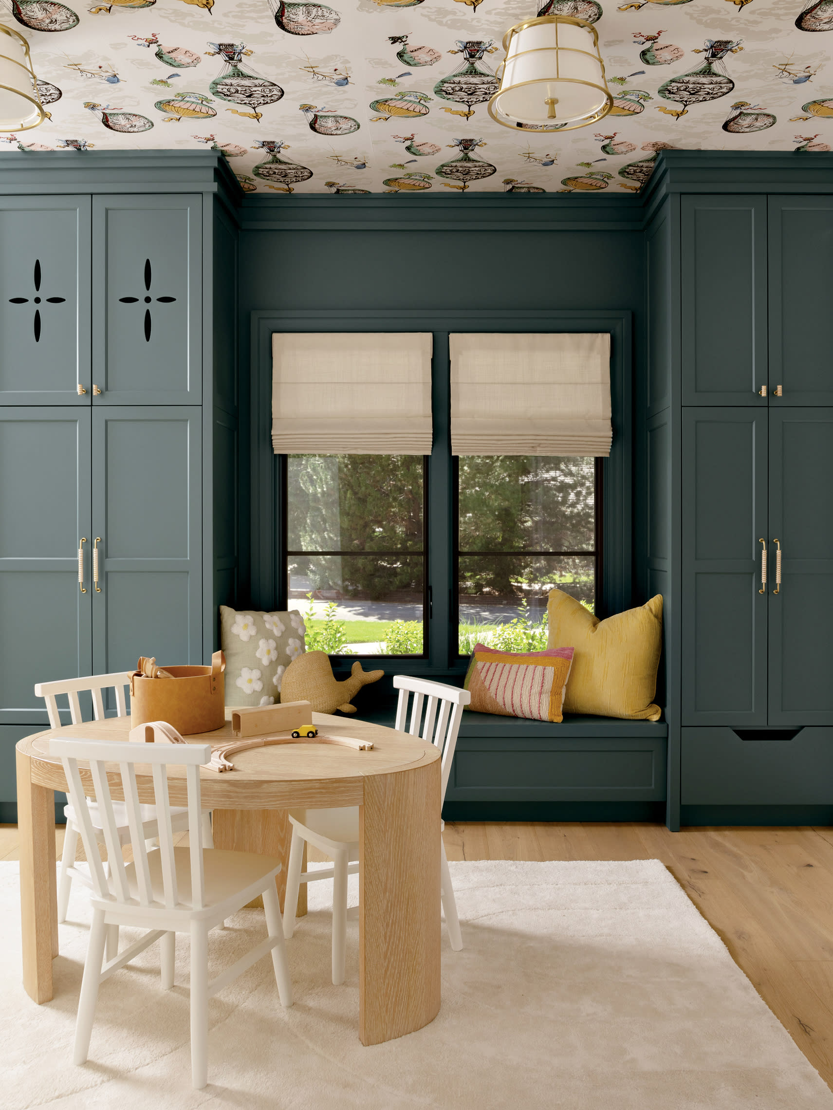 playroom with shaker-style cabinetry and a hot air balloon theme wallpaper on the ceiling