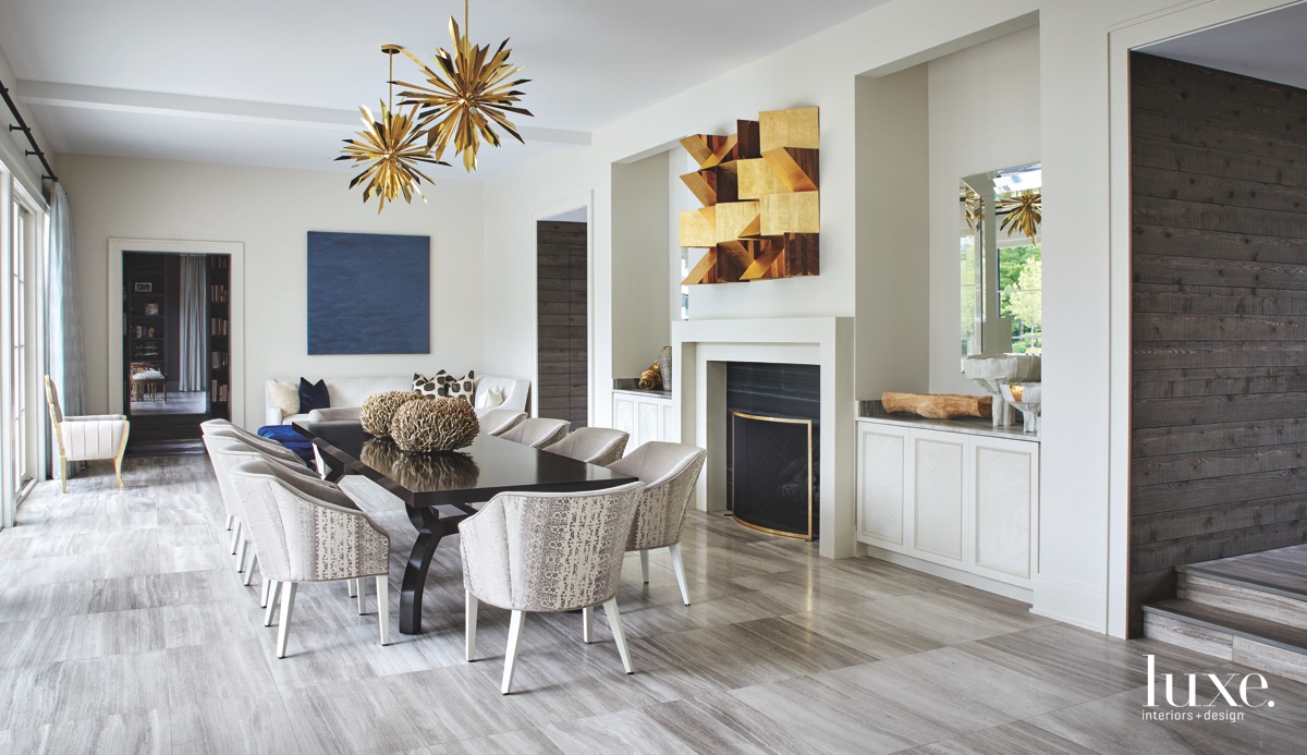 industrial dining room with sunburst gold chandeliers in home by Michelle Williams