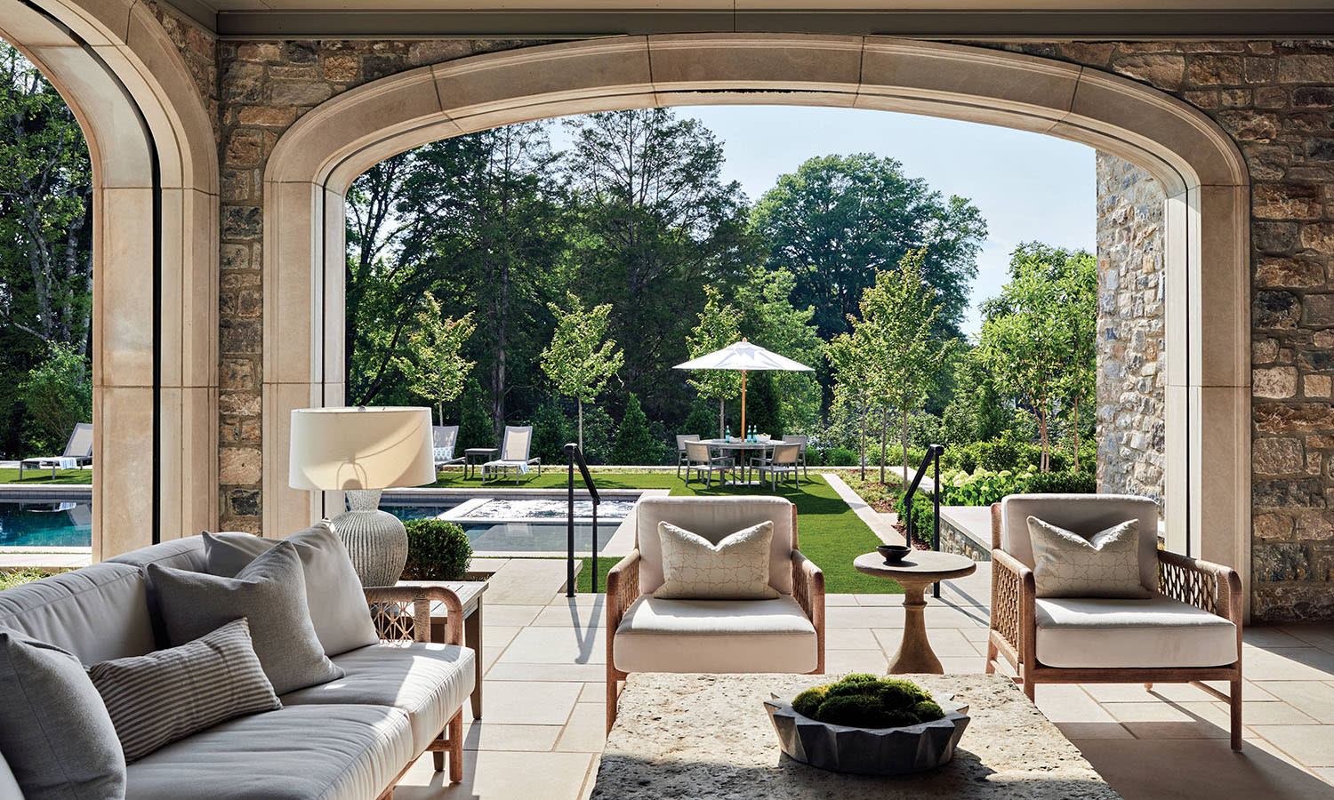 traditional covered porch with arched niches and lounge seating