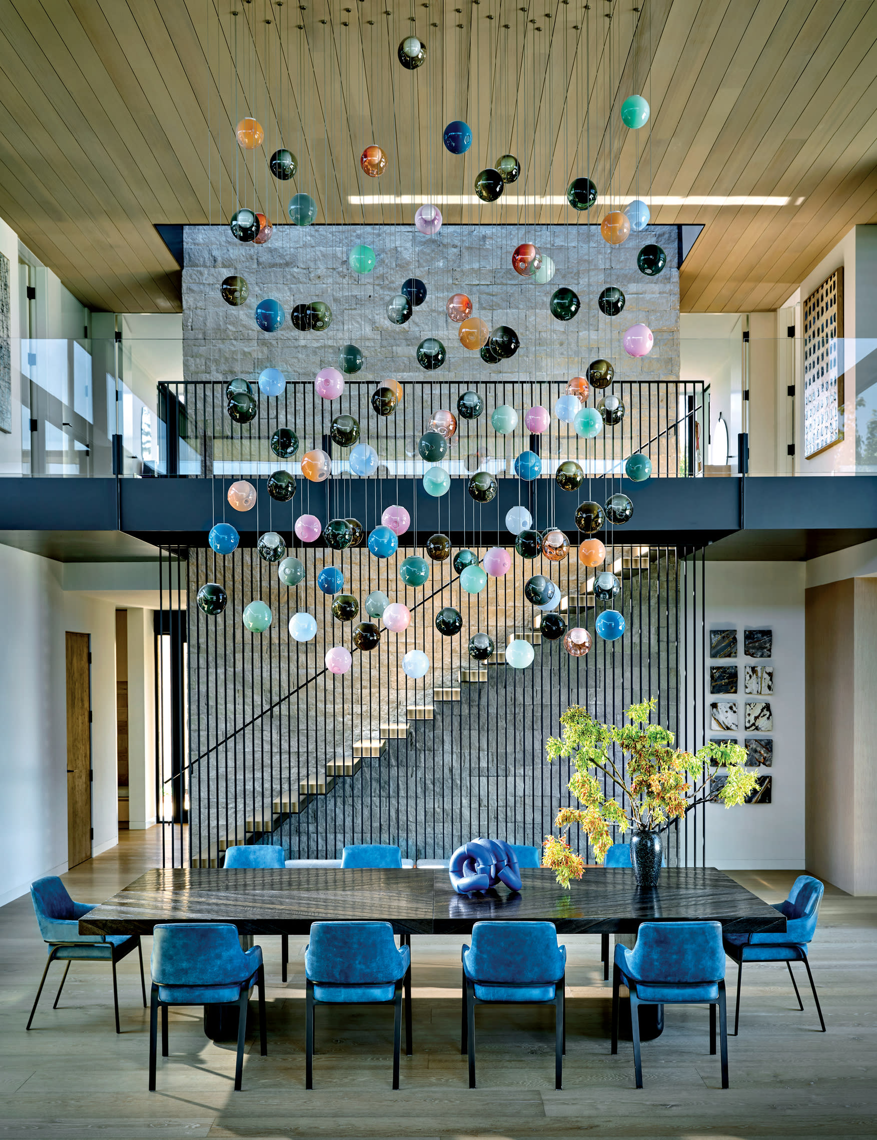 blue dining room with handblown glass light fixture and reclaimed wood dining table 