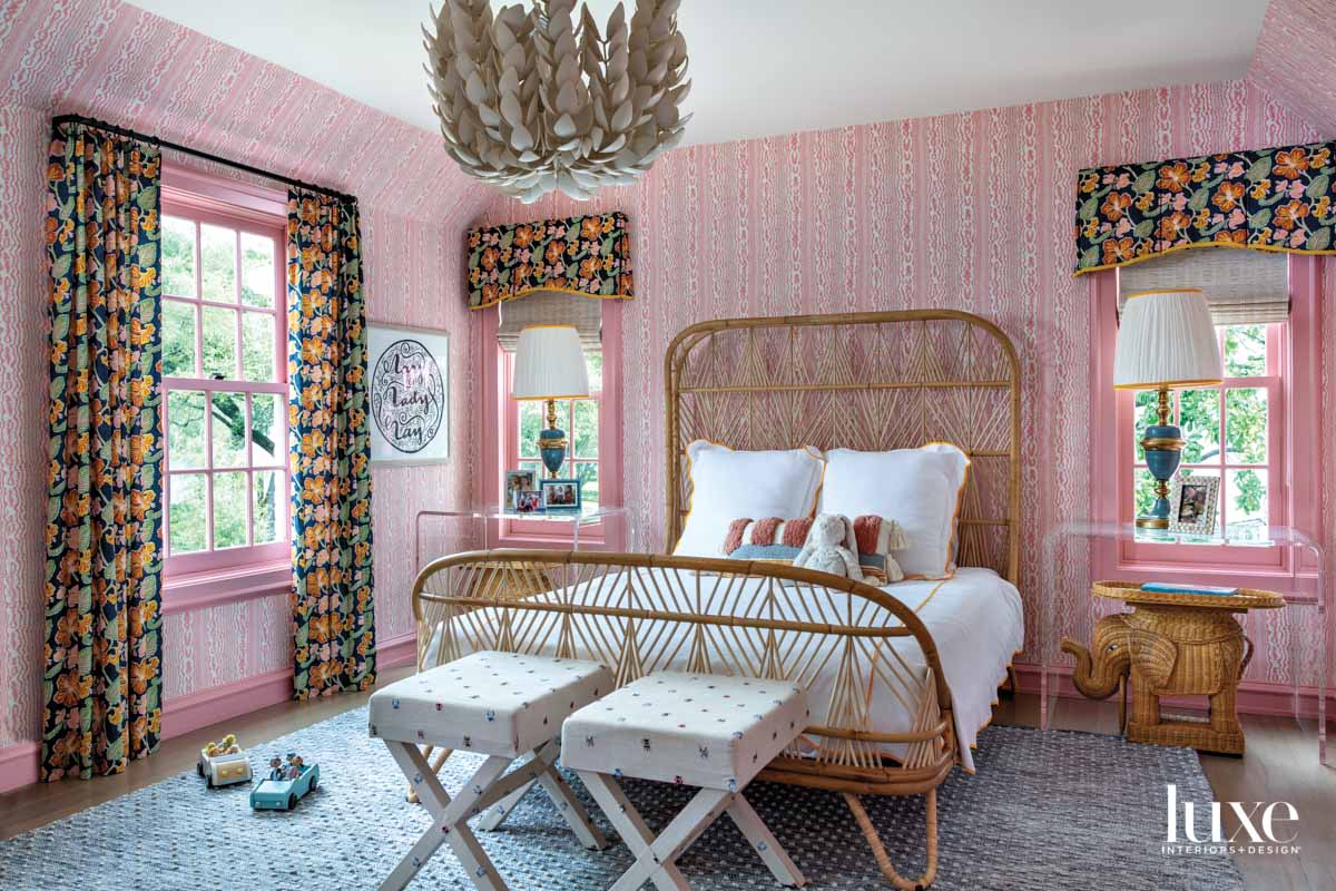 Colorful girl's bedroom with wallpaper and rattan bed