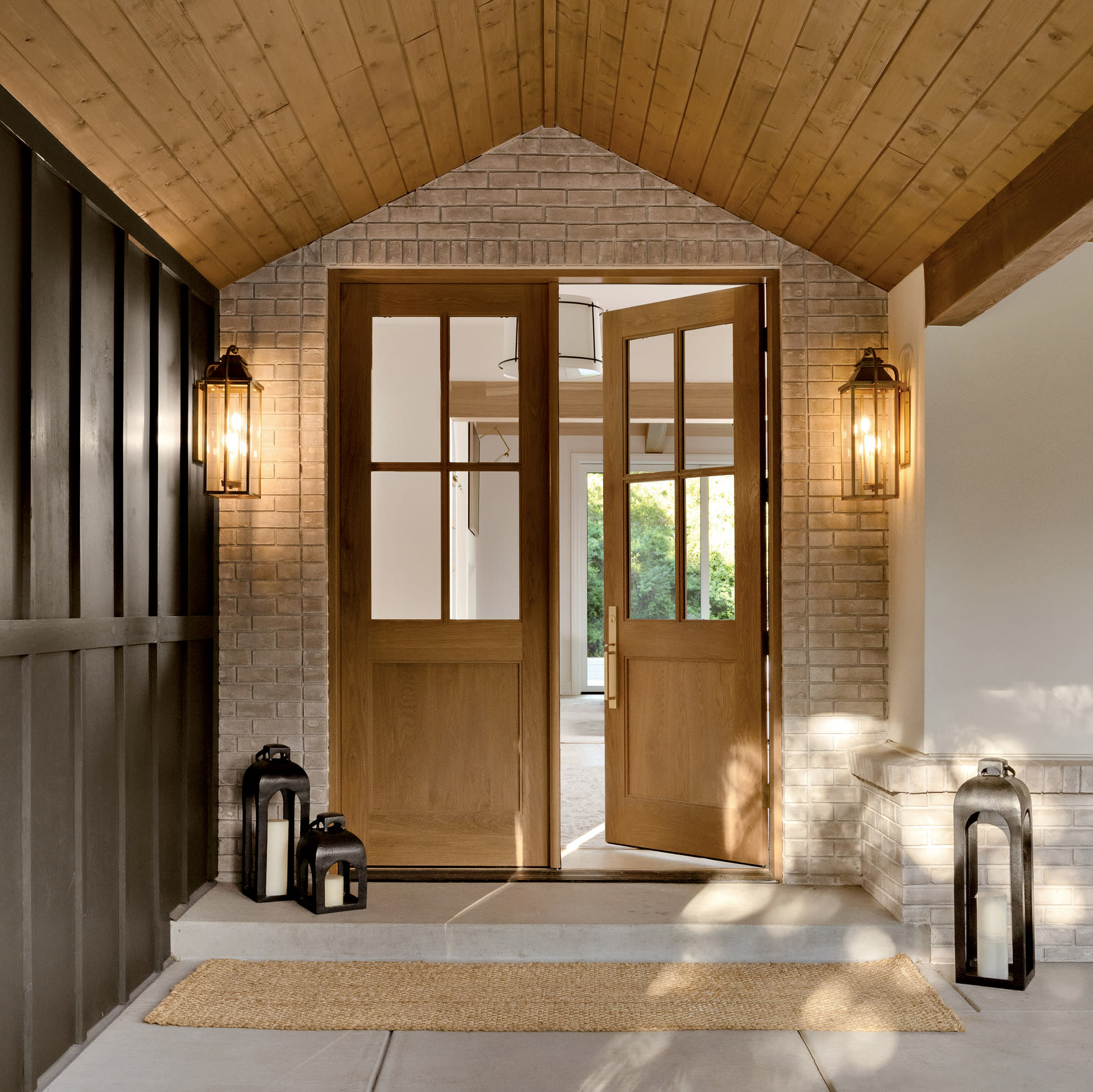 classic entryway with sconces next to the doors 