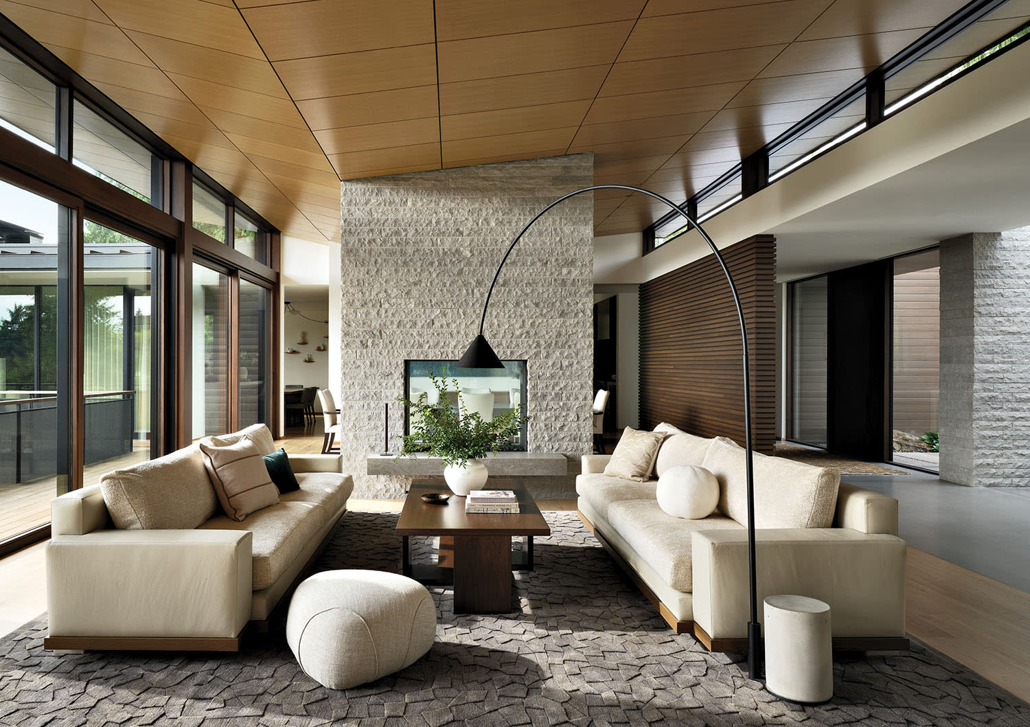 angled ceiling above a stone fireplace in a modern home living room