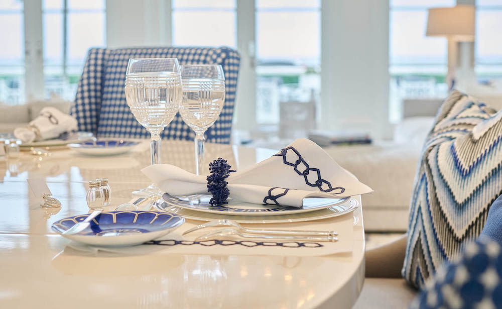 A dining table set with blue and white plates and coordinated place settings, showcasing a stylish and inviting table design.