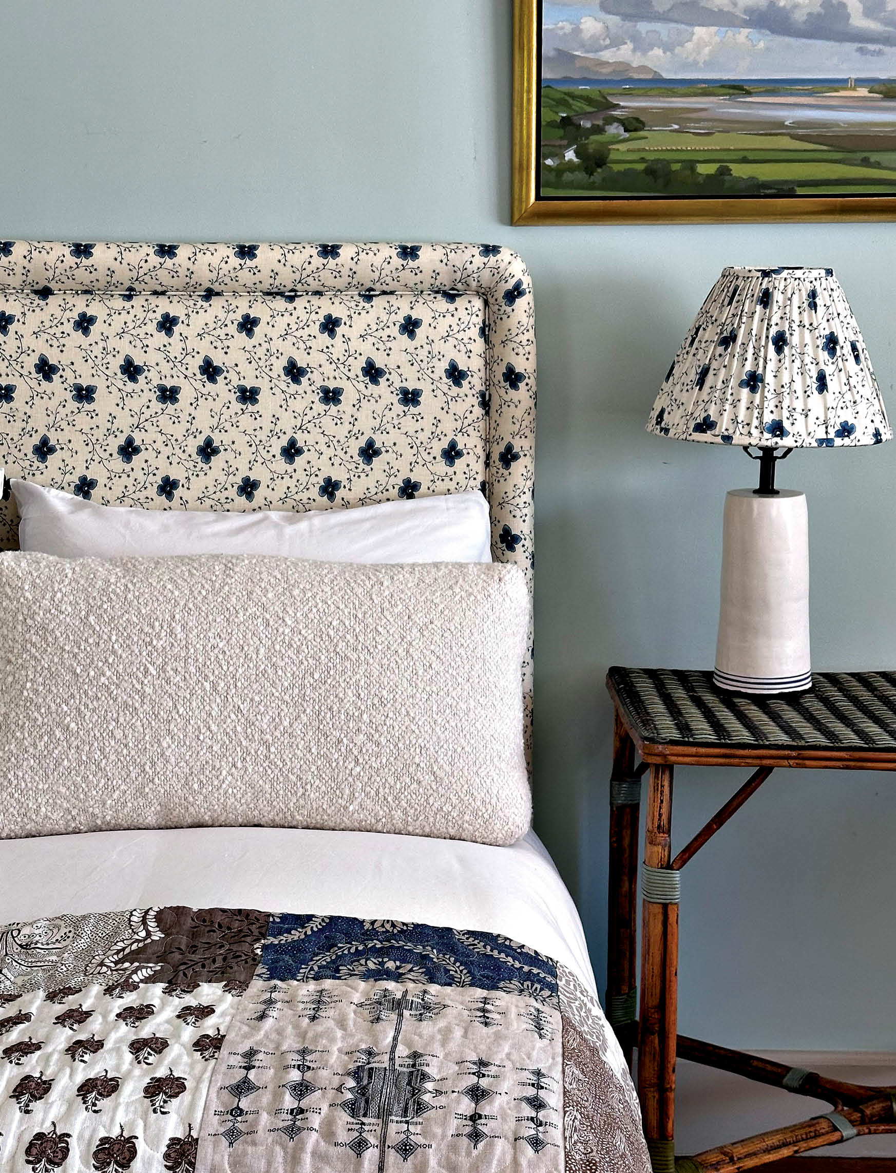 vintage-inspired fabric upholstered bed with a matching lampshade