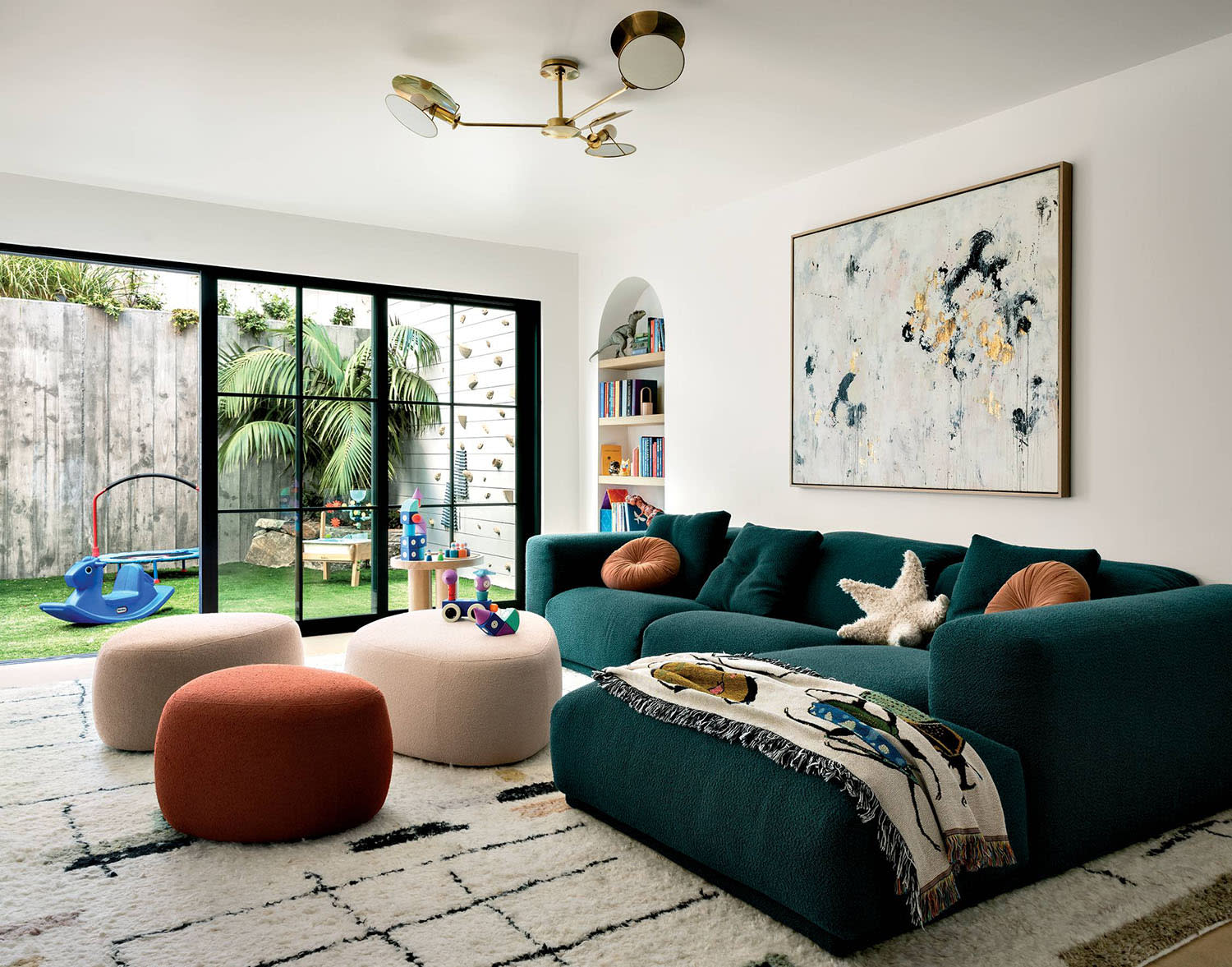 contemporary family room with a dark green sectional from Design Within Reach